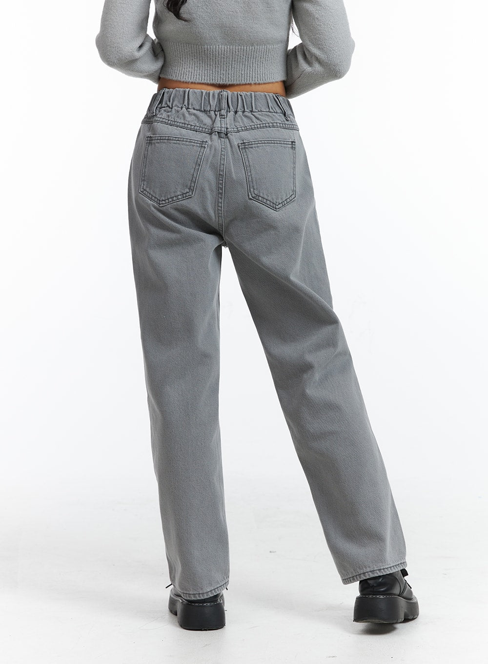 Low-Rise Straight Leg Jeans OJ426 in gray, back close-up on model, highlighting elastic banded waistband detail, dual back pockets, and wide-leg washed denim silhouette.
