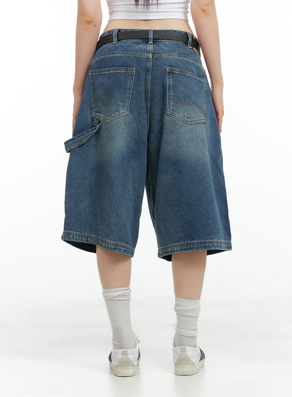 Stud Washed Baggy Jorts (UNISEX) CG408 in blue, back view on model, wide-fit half-length denim with dual back pockets, carpenter panel, black belt, and sneakers.