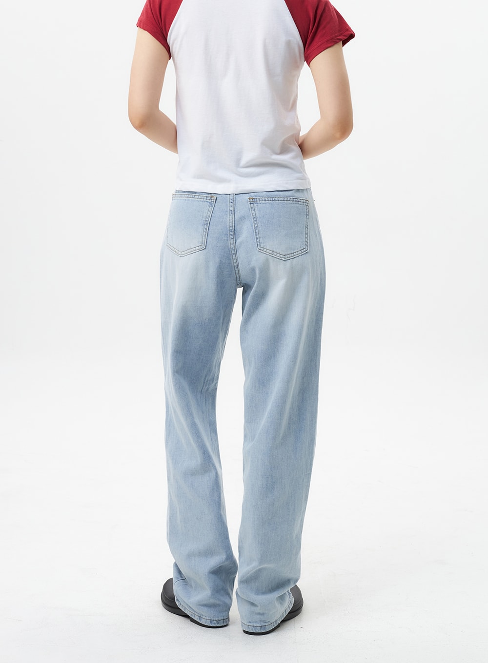 Wide Straight Leg Jeans OL304 in light blue, back view on model, dual back patch pockets with topstitching, wide-leg cotton denim with faded wash and straight hem.