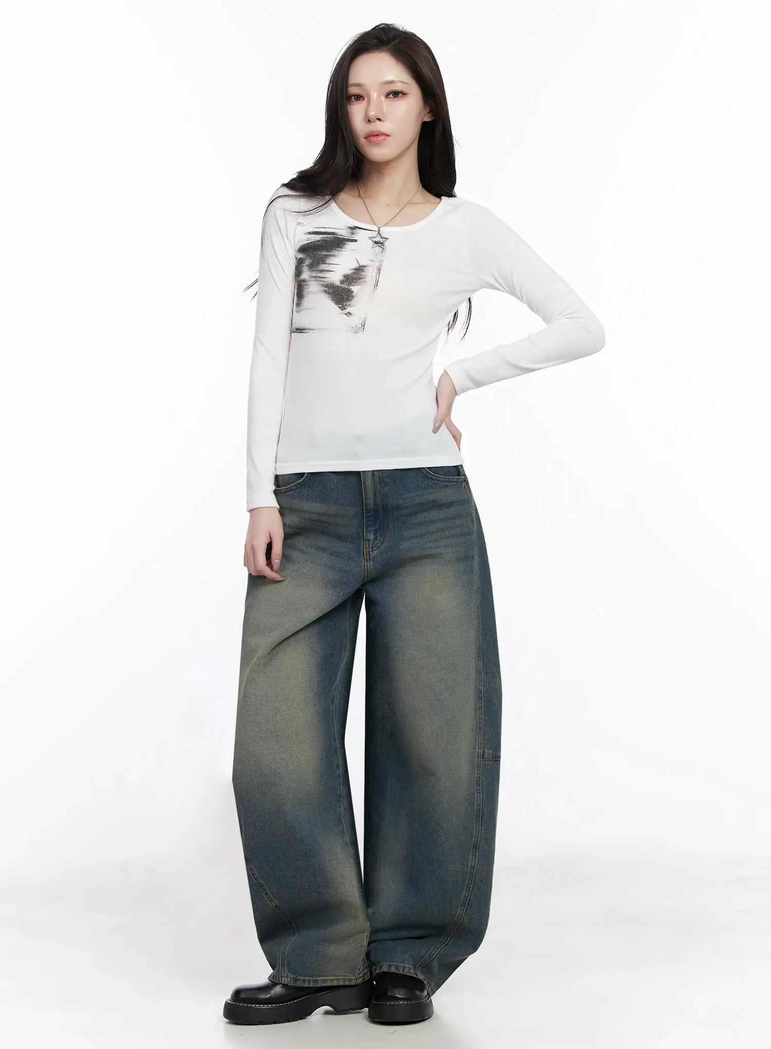 Tata Vintage Dark Blue Washed Wide Leg Jeans IJ528 in dark blue, front full-length styling shot, model wearing white graphic long-sleeve top and necklace, oversized balloon-leg denim with washed fading, black platform loafers.