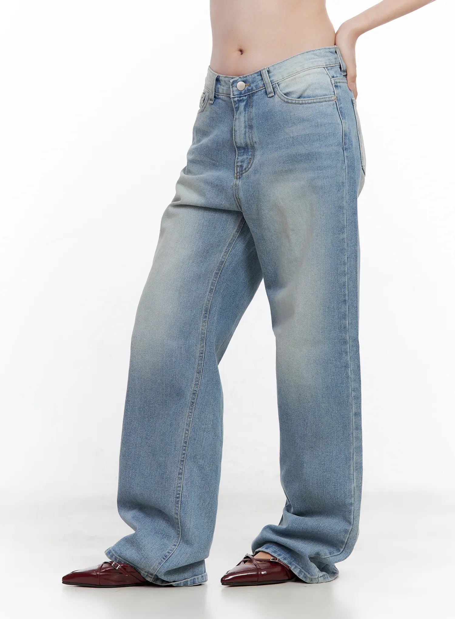 Ina Slouchy Fit Jeans CL502 in blue, side close-up on model, washed cotton denim highlighting low-rise waistband, wide slouchy leg silhouette and front pocket detail, burgundy loafers.