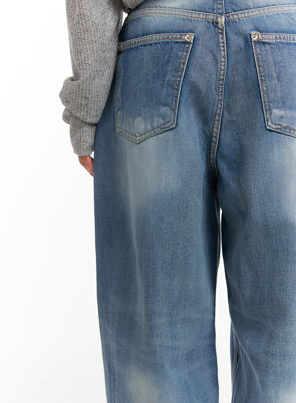 Comfy Wide Fit Baggy Jeans CA408 in blue, back close-up detail showing two patch pockets with silver rivets and sun-faded washed denim texture across seat and thigh.