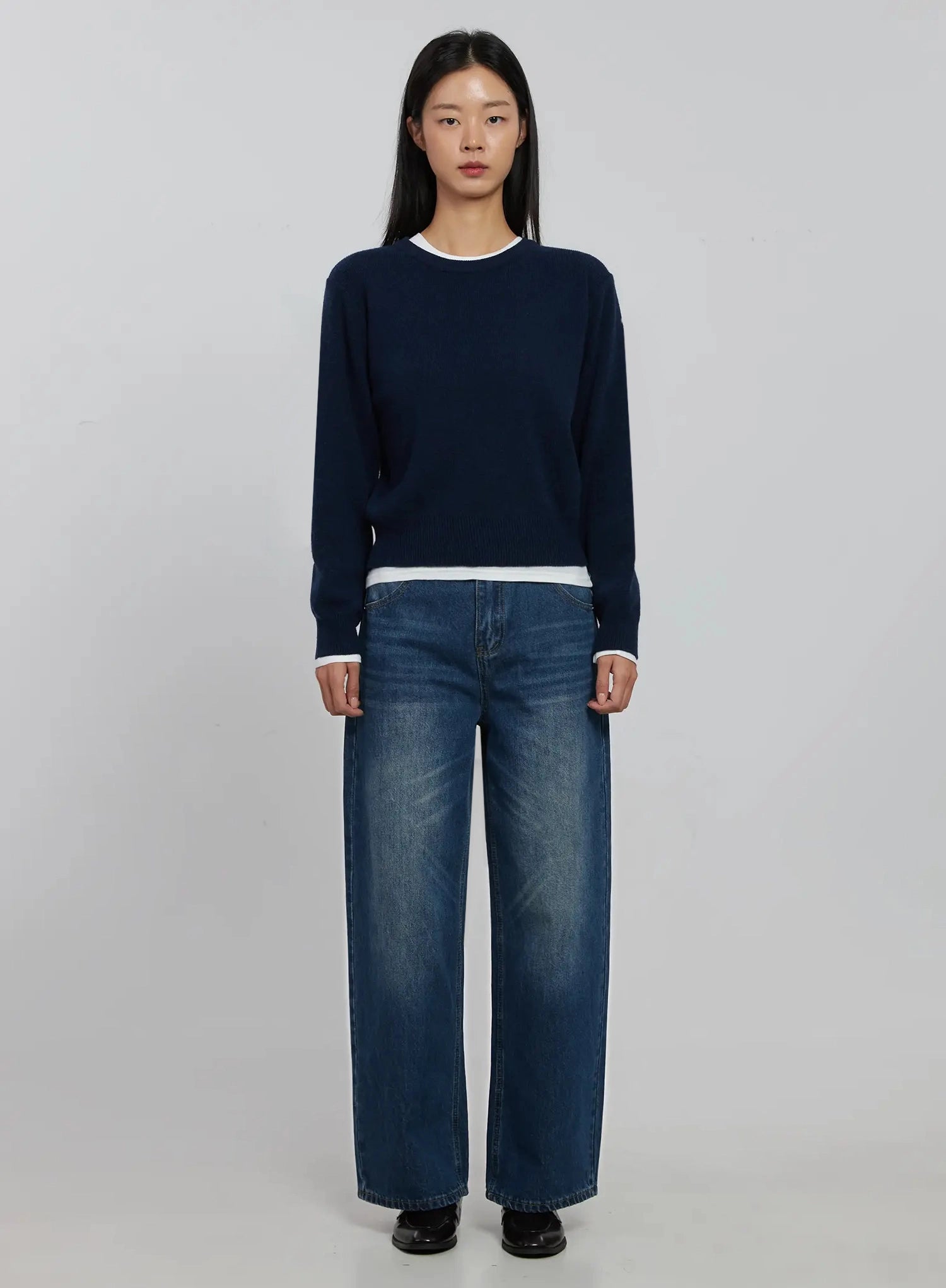 Alaina Wide Leg Jeans IJ508 in dark blue, full-length front view on model, paired with navy layered crew-neck knit sweater, loose wide-leg fit, black loafers.