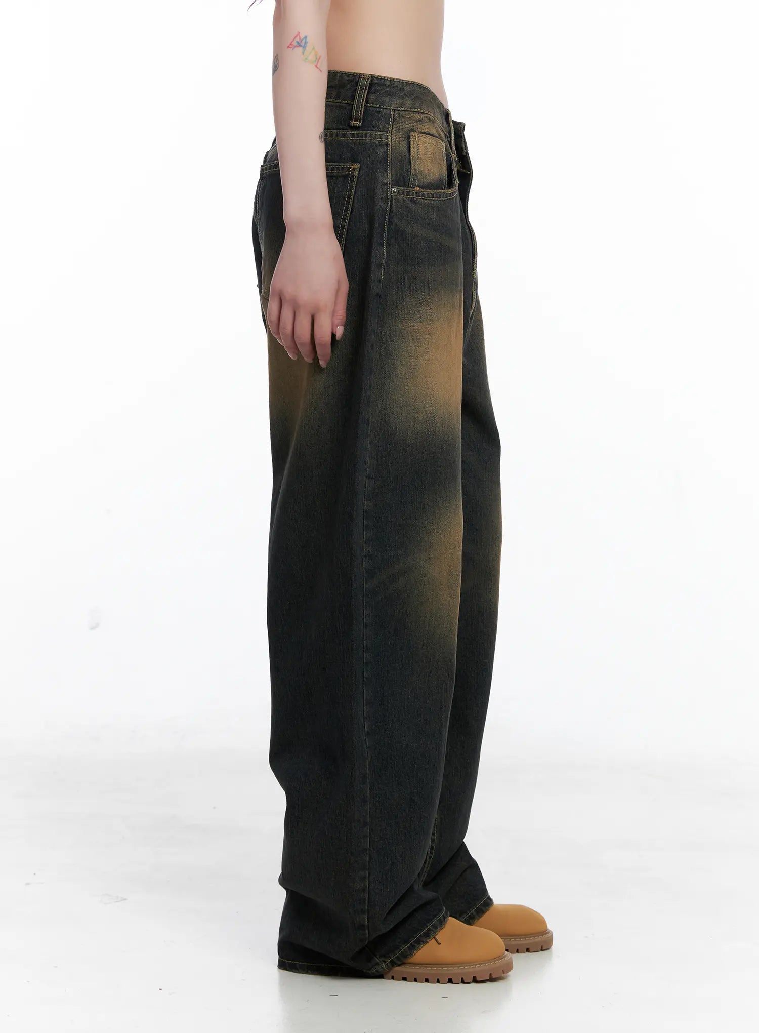 Leona Vintage Baggy Jeans CS526 in dark blue, side product view on model, full-length wide-leg silhouette with amber gradient vintage wash and side pocket detail, tan boots.