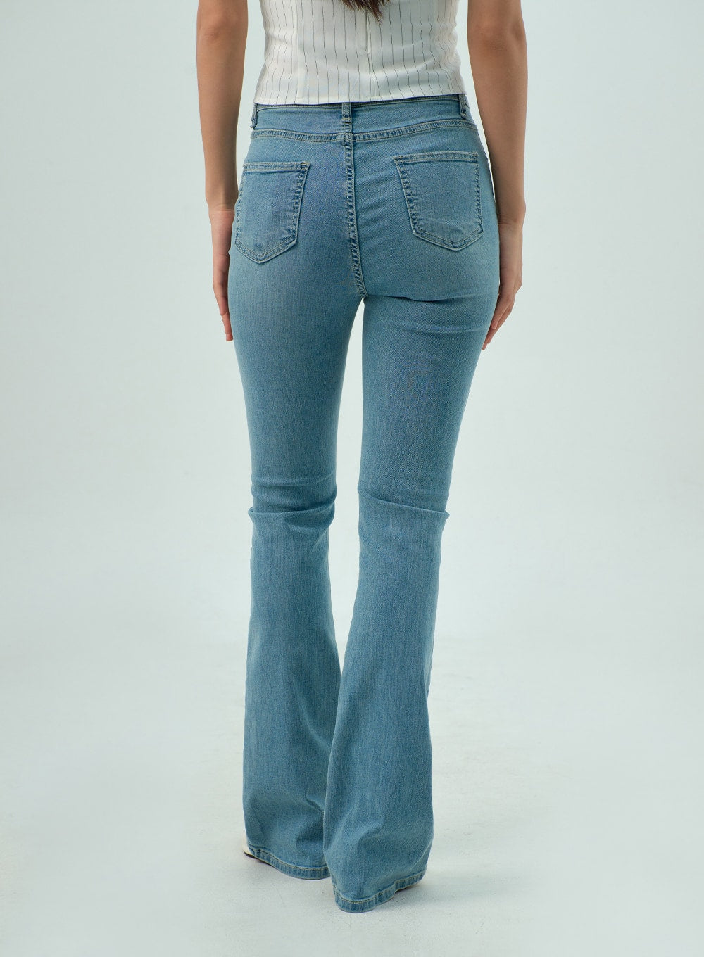 Light Wash Bootcut Jeans CY330 in light blue, back cropped view on model, dual back patch pockets with stitching detail, slim fit through seat and thigh, gentle bootcut flare below knee.