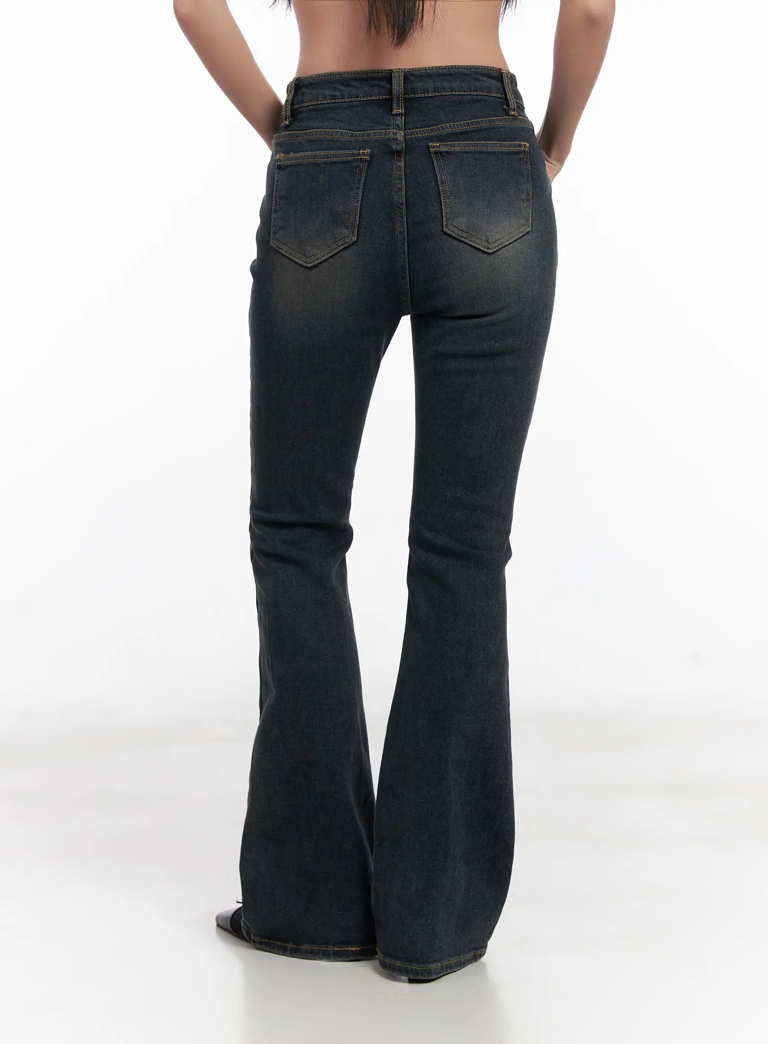 Jay Dark-Wash Bootcut Jeans CD501 in dark blue, back waist-to-hem product shot on model, dual back pockets with gold contrast stitching, washed finish, flared bootcut silhouette.