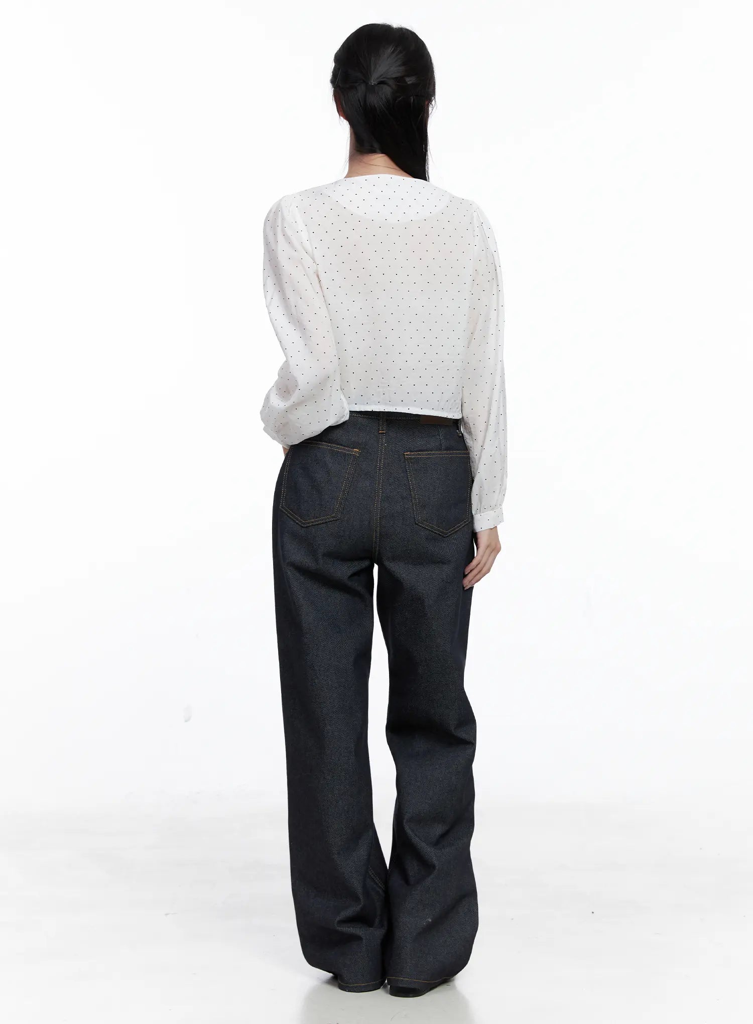 Reyna Non-Fade Relaxed Jeans CS519 in dark blue, full-body back worn by model, wide-leg cotton denim with back pockets and gold topstitching, paired with white polka-dot crop top, standing pose.