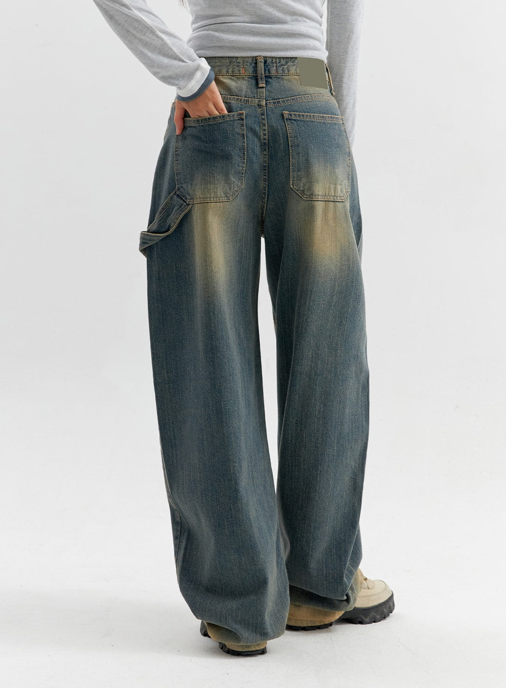 Vintage Wash Wide Leg Jeans CO306 in blue, back view on model, patch back pockets and carpenter side pocket, yellow-faded vintage wash, wide straight leg, gray waistband accent.