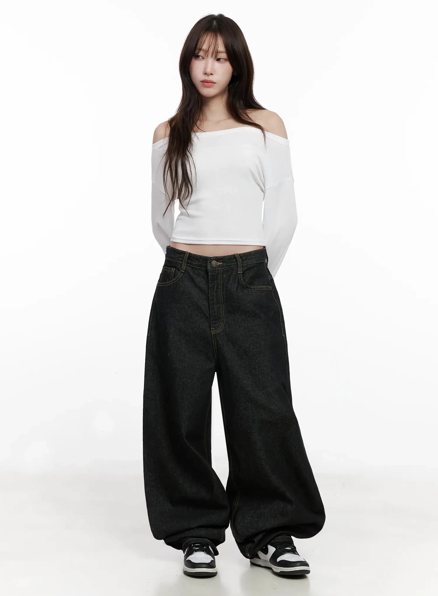 Halo Wide Leg Stitch Detail Jeans IN514 in black, full-body front on model, oversized cotton wide-leg denim with gold stitch, paired with white off-shoulder crop top and black-white sneakers.