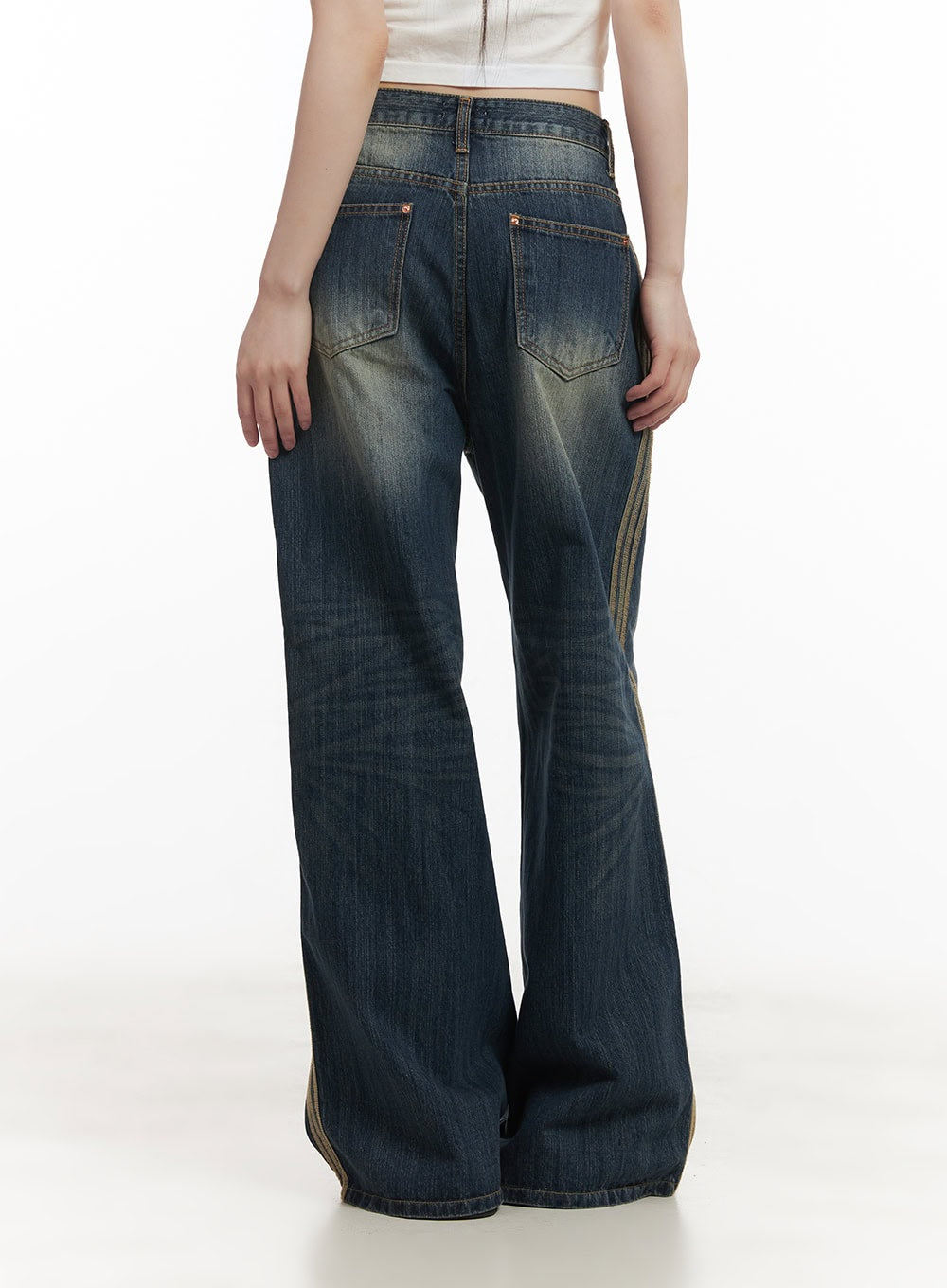 Daisee Striped Wide-Leg Jeans CF518 in dark blue, back view close-up on model, showing dual back pockets, washed fading, and side gold triple stripe on wide-leg cotton denim.