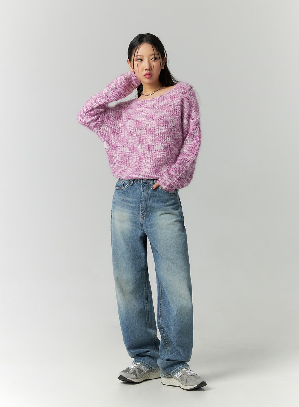 Straight Fit Jeans CN324 in blue, full-length front view on model with hand raised, wide-leg washed denim, casual street style, paired with pink marled knit sweater.