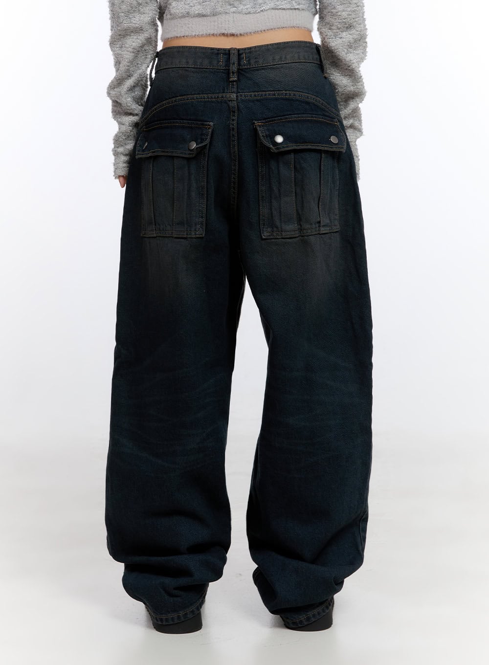 Lyla Wide Leg Jeans CO423 in dark blue, back full view on model, wide-leg silhouette with large snap-flap back pockets and faded washed finish, hem stacking at ankles.