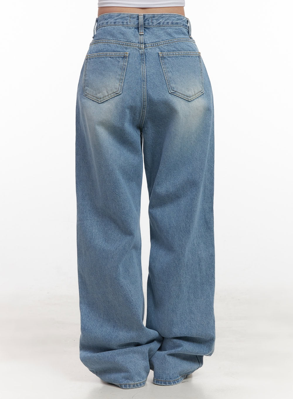 Kelly Washed Baggy Jeans CJ514 in light blue, back product close-up on model, dual back pockets with arrow stitching detail, washed cotton denim with wide baggy fit.