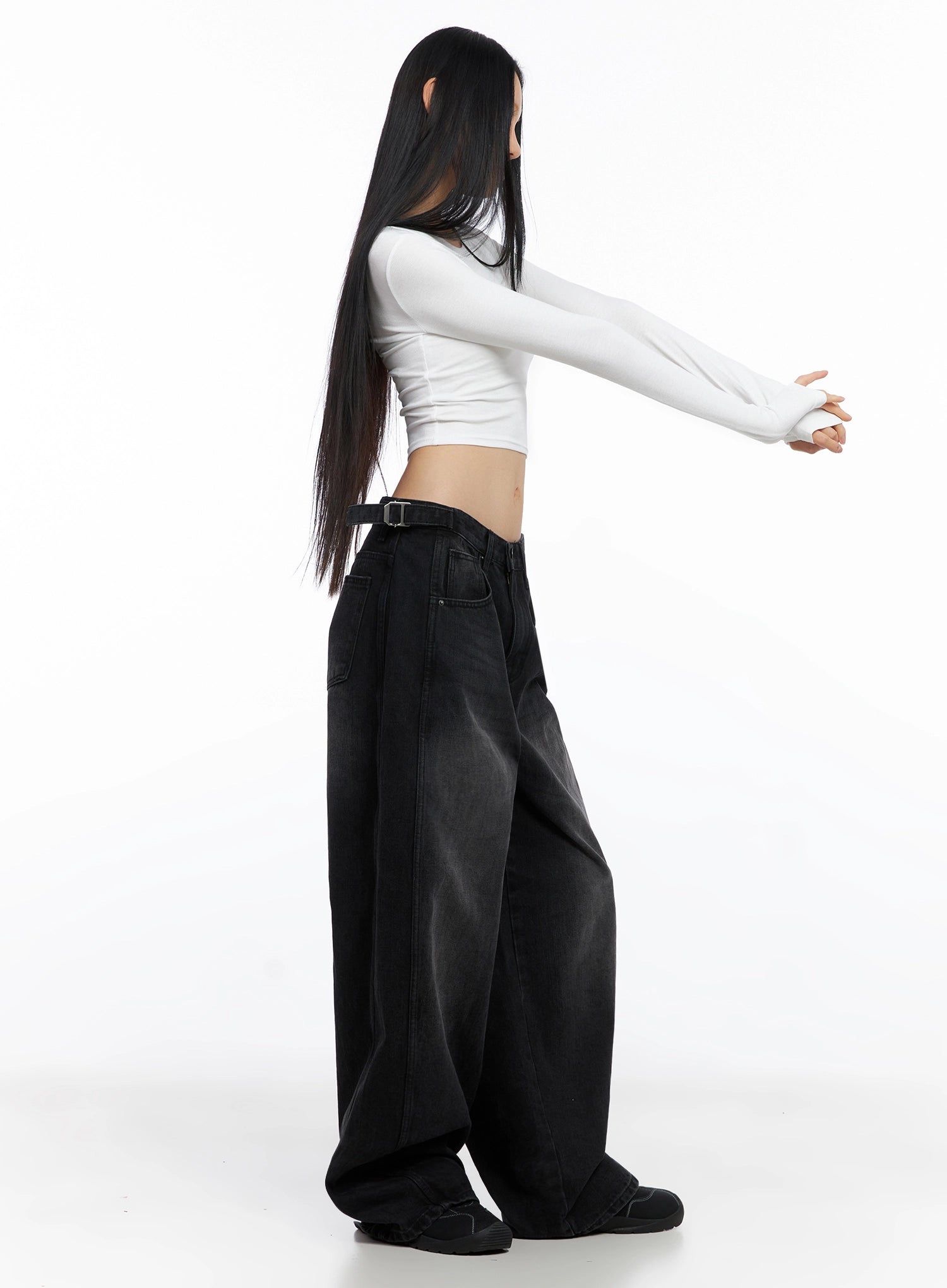 Goffel Side Belt Washed Wide Denim Pants IO517 in black, side view on model with arms extended, showing side belt detail, wide leg volume, and washed gradient from waist to hem.