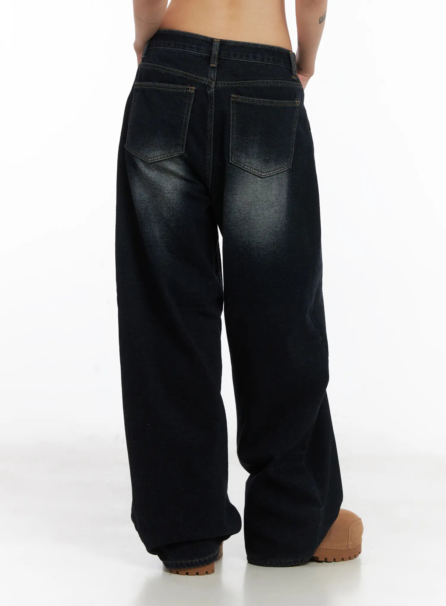 Soph Fleece-Lined Washed Wide-Leg Jeans CD509 in dark washed indigo, back close-up on model, showing dual rear patch pockets with contrast stitching and relaxed wide-leg hem pooling over boots.
