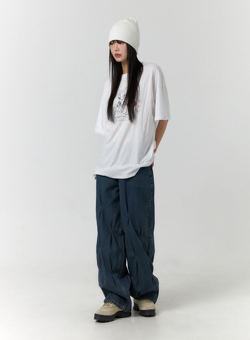 Quilted Wide Leg Denim CF406 in dark blue, full-length three-quarter front shot on model, relaxed wide-fit with quilted pintuck legs, styled with white graphic tee, beanie, and sneakers.
