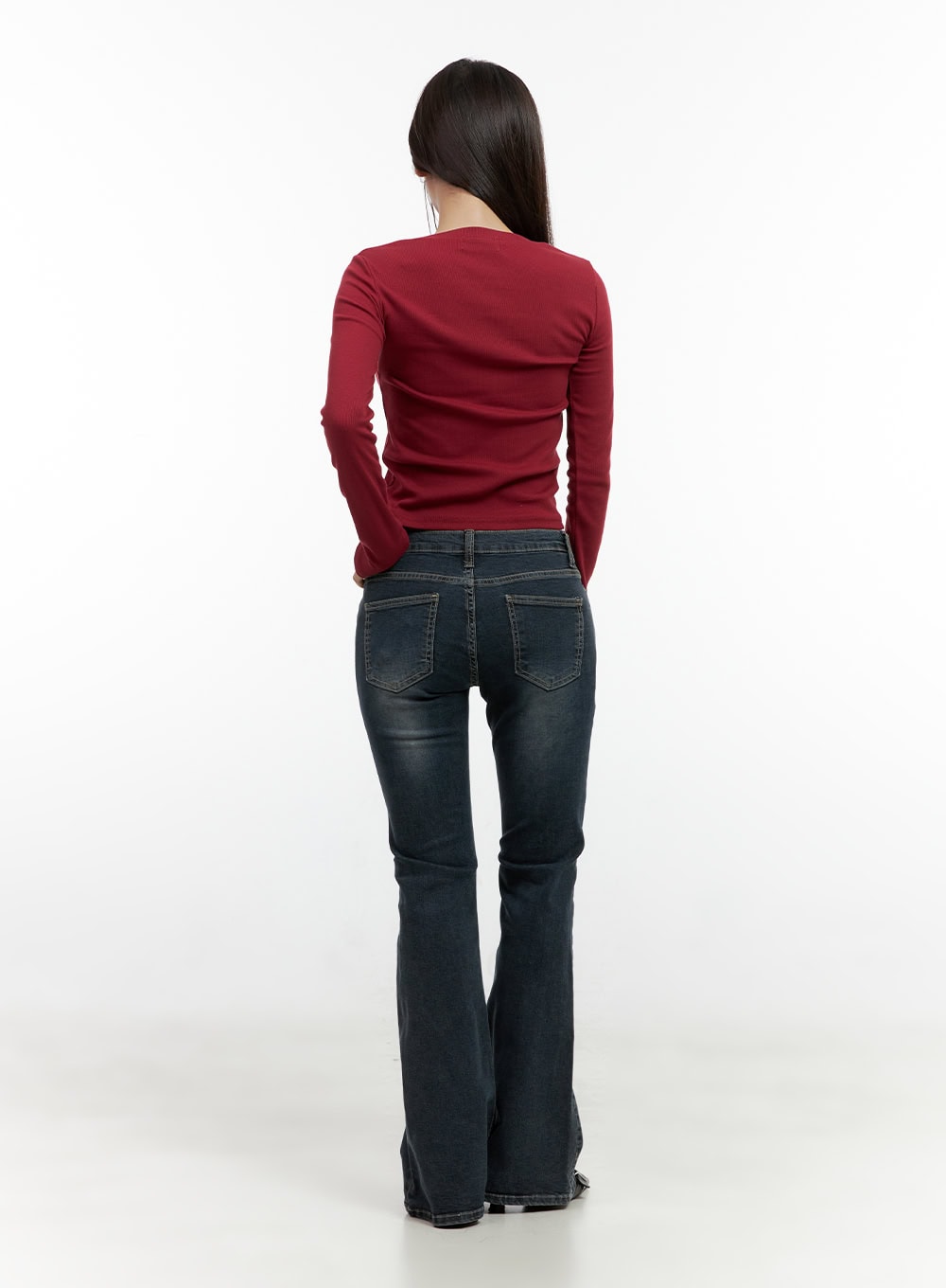 Ingrid Low-Rise Washed Flared Hip Pad Denim Jeans CN404 in dark blue, full-body back shot on model, back pocket detail and flared bootcut hem, washed cotton-spandex denim, styled with red top.