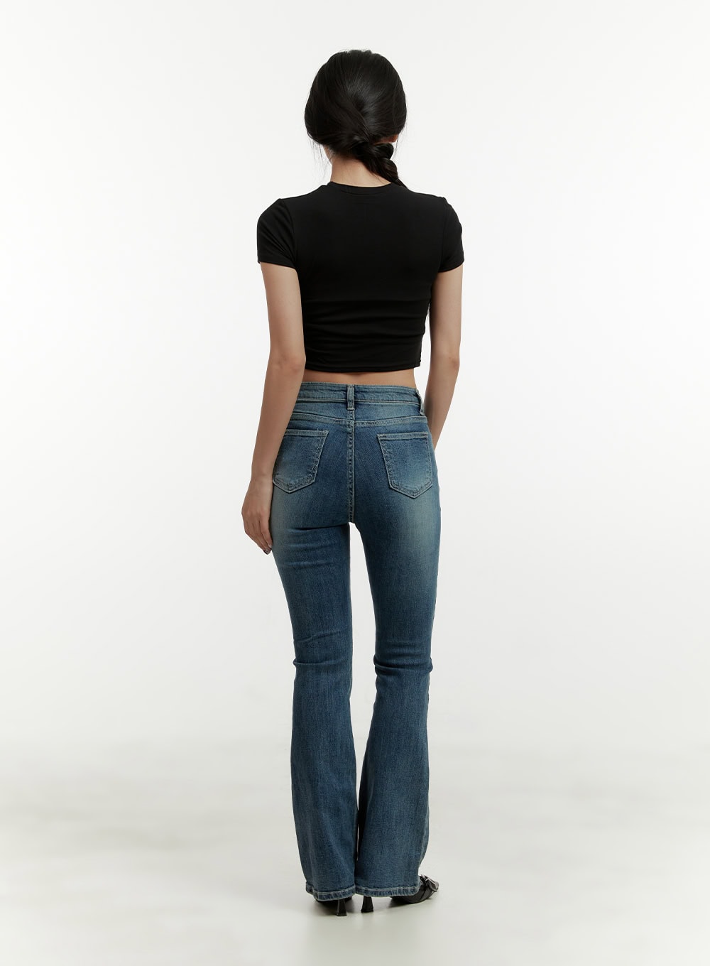Low Rise Bootcut Jeans CY409 in blue, full back view on model, bootcut flare leg, washed denim, paired with black crop tee and kitten heels.