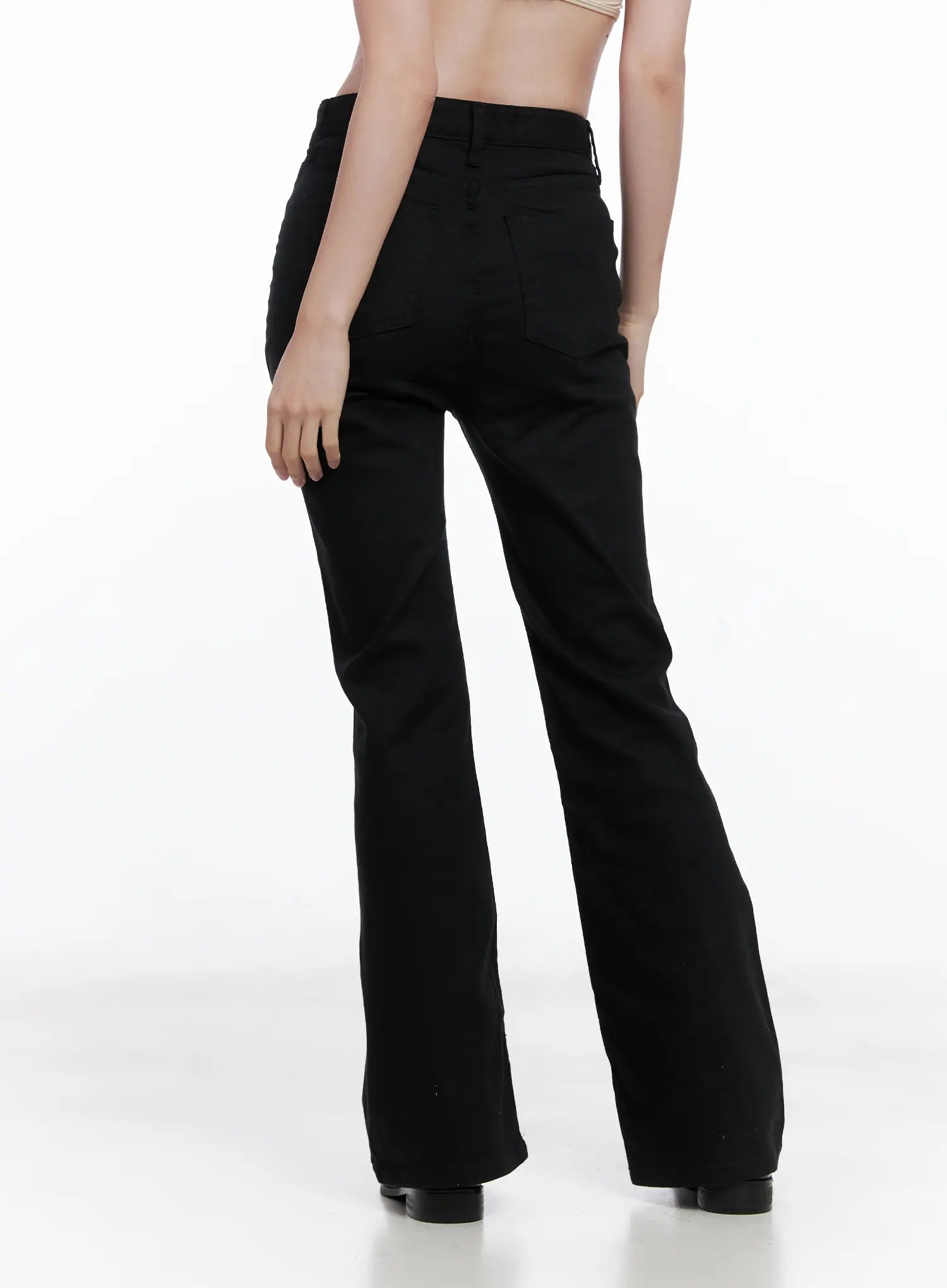 Casual Flare Cotton Pants CG521 in black, back view on model, showing rear patch pockets, high waist, and flare hem silhouette in solid black cotton-spandex fabric.