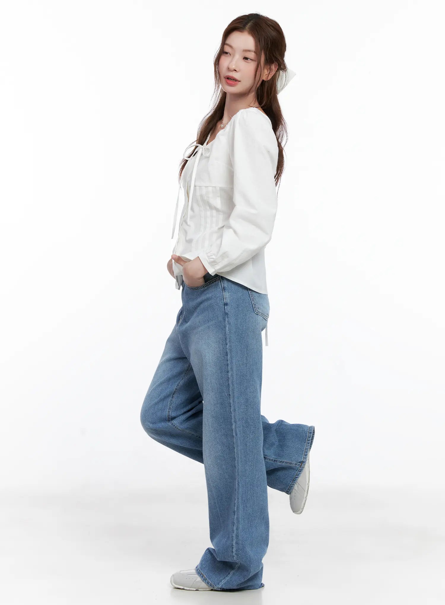 Jung Straight-Leg Washed Jeans CG521 in blue, full-length side shot on model with one leg raised, paired with a white tie-front blouse, showing relaxed straight-leg length and washed finish.