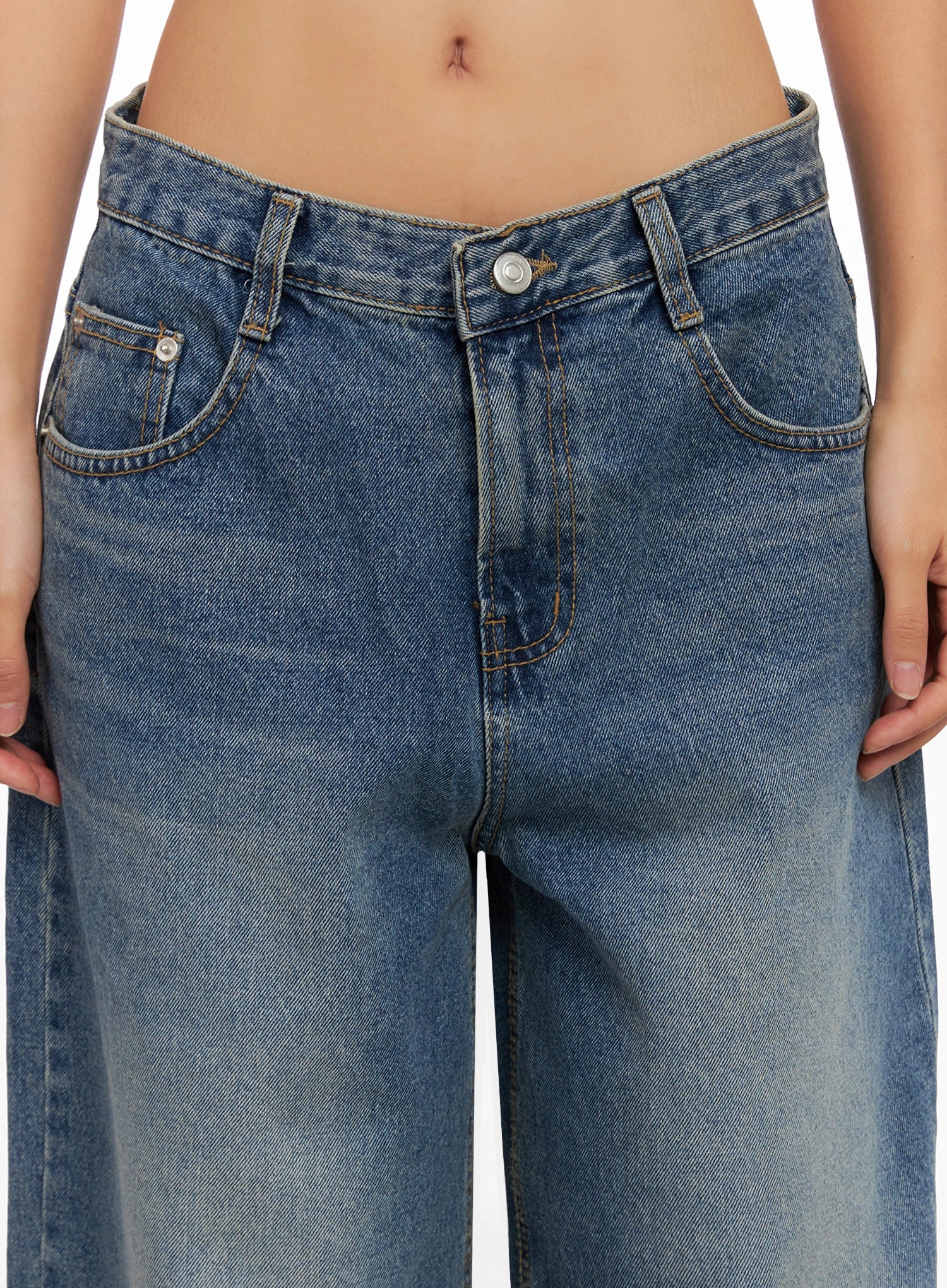 Lilah Wide-Leg Washed Jeans IG527 in mid-blue, close-up of waistband and front pockets on model, button closure, contrast stitching, and washed denim texture visible.