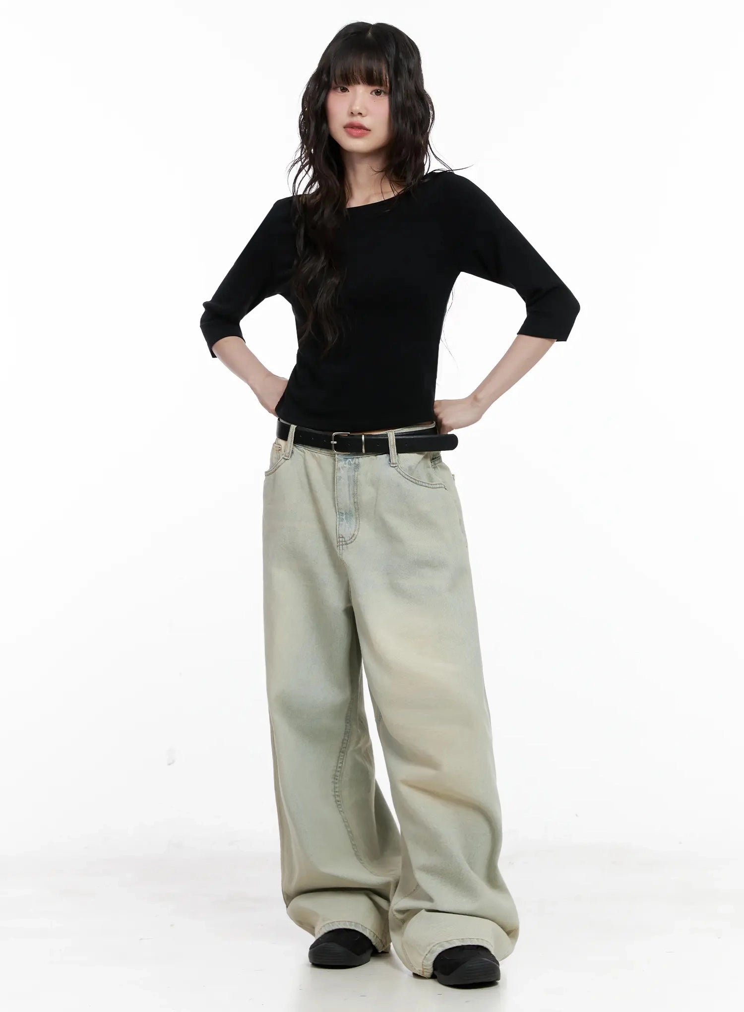 Xiaoting Vintage Style Wide-Leg Denim IL531 in light blue, full-length front shot on model hands on hips, exaggerated wide-leg sweep, vintage washed cotton, styled with black top and belt.