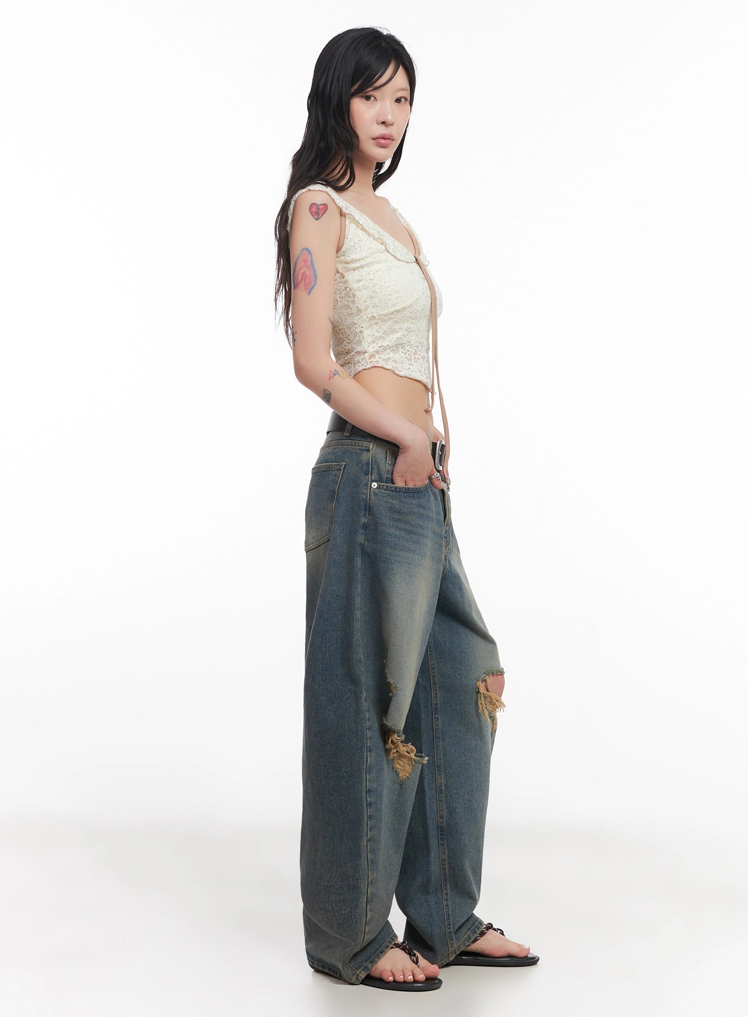 Jeemin Vintage Distressed Wide-Leg Denim Jeans IC503 in washed blue, side view on model, showing voluminous wide-leg silhouette, faded wash, and knee-area distressing, paired with lace top.