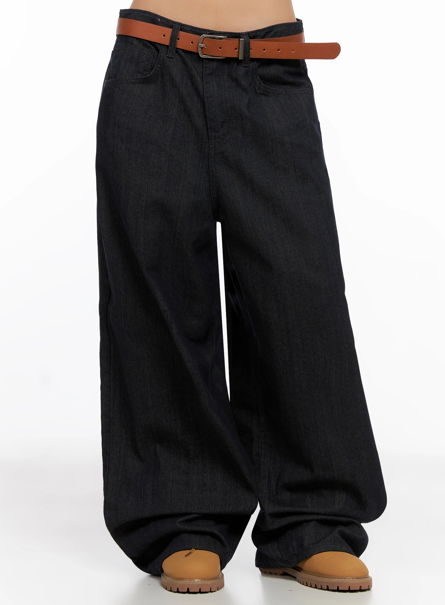 Heidi Wide-Leg Jeans IG527 in dark blue, front lower-body view on model, showing ultra-wide leg silhouette with subtle denim texture, brown belt at low rise, tan boots beneath pooled hem.