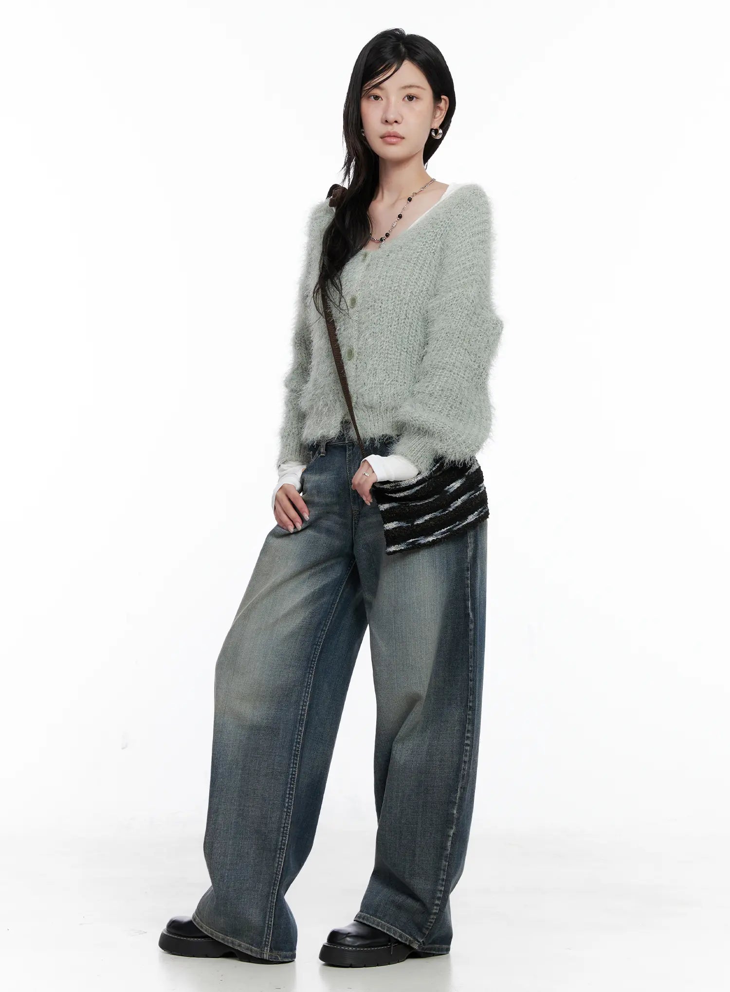 Nellie Baggy Jeans CS526 in blue, full-body styled shot on model, paired with sage fluffy knit cardigan and striped mini bag, wide-leg washed denim in casual K-street look.
