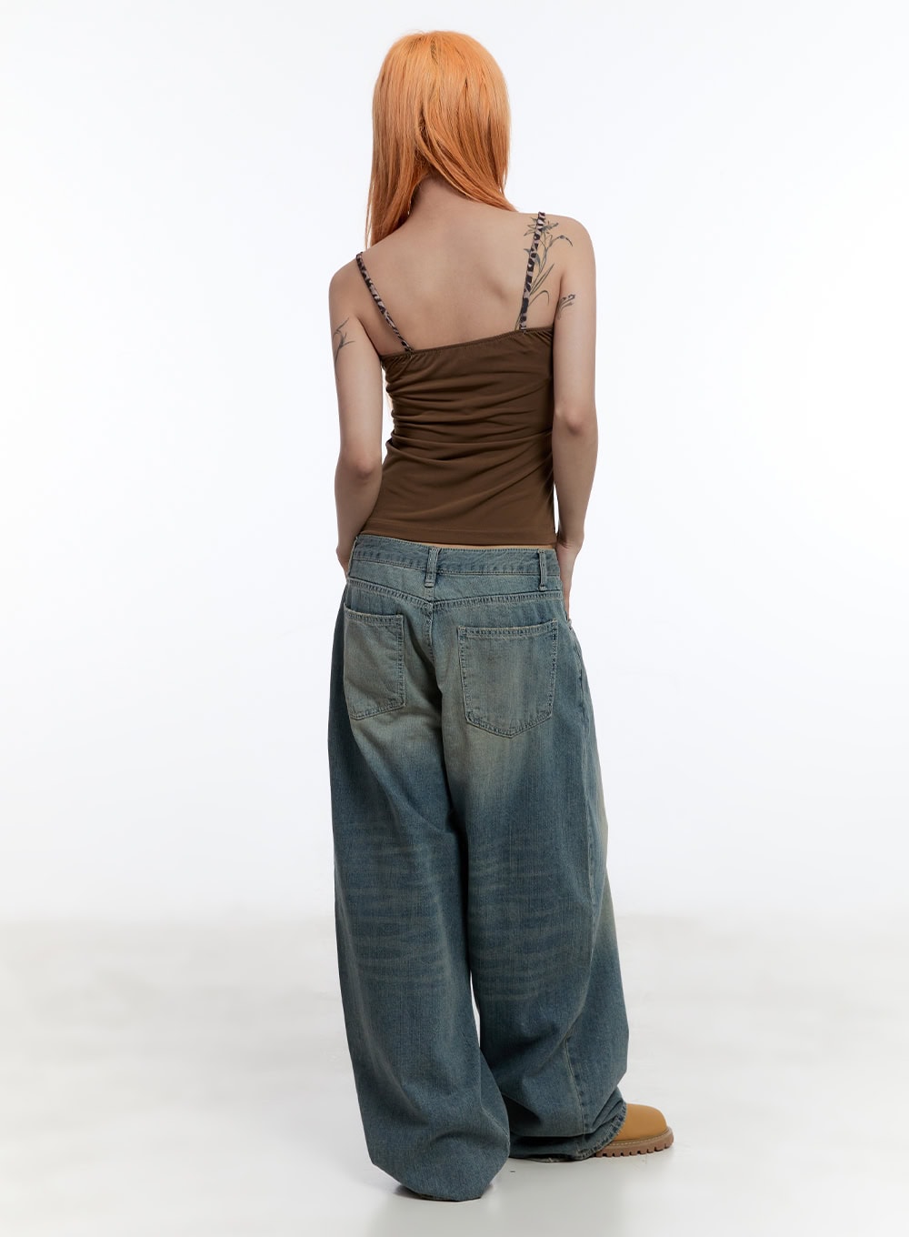 Jenna Relaxed-Fit Wide-Leg Jeans CU502 in blue, full-length back on model, oversized washed denim with dual back pockets and wide leg, paired with brown cami top.