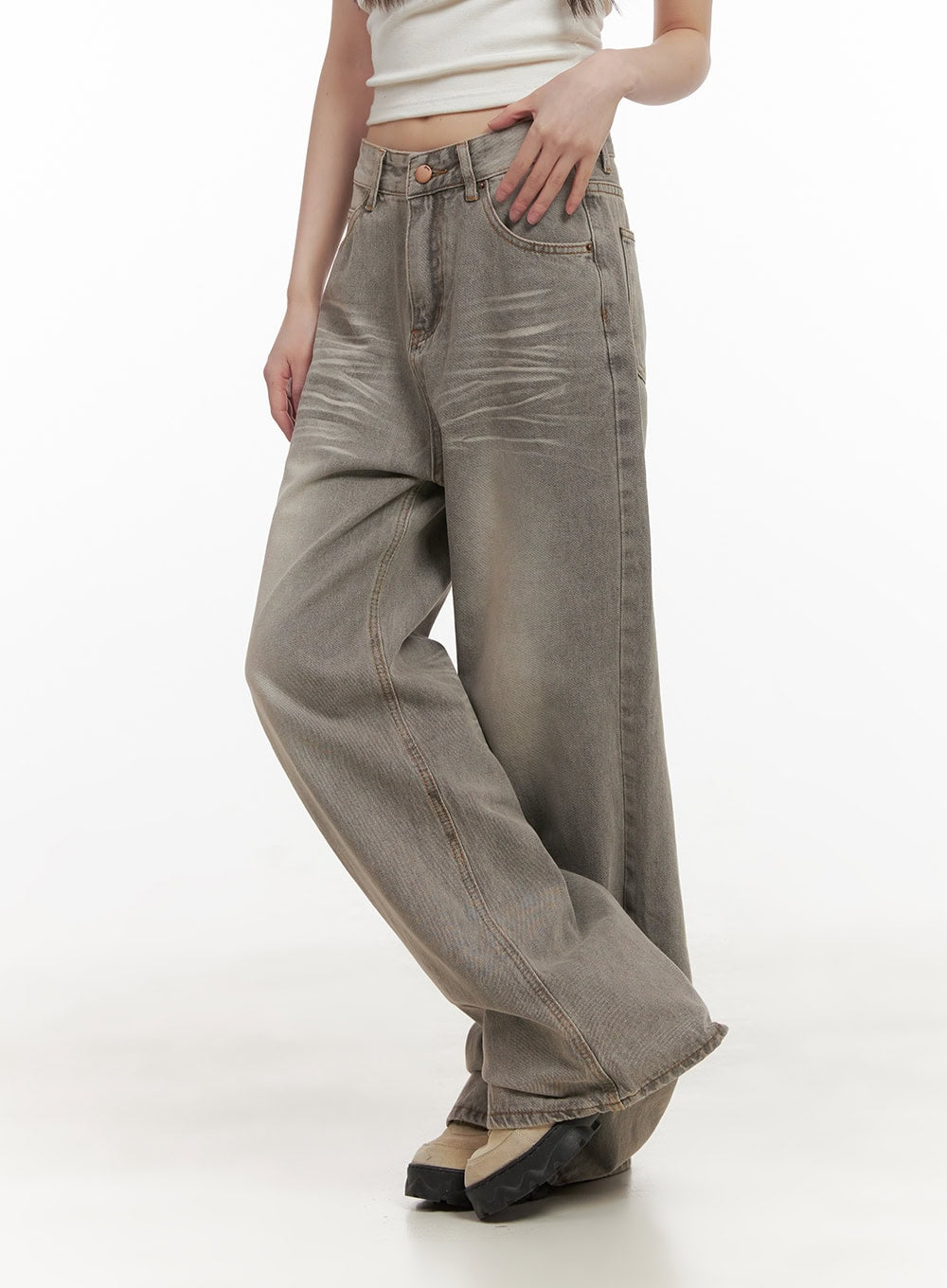 Hollie Vintage Wide-Leg Jeans CD426 in gray, angled front close-up on model, washed denim with visible whisker creases, front pockets, copper button waistband, and white crop top.