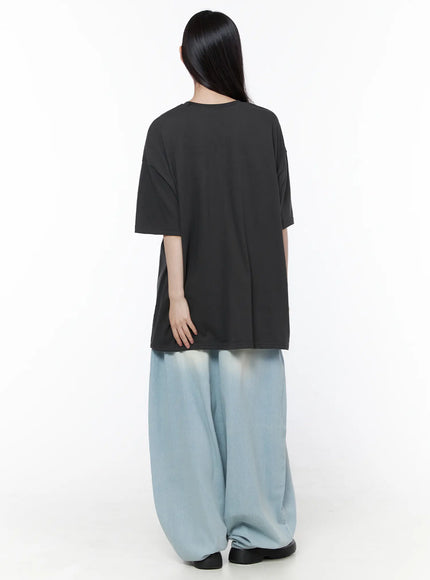 Ozzy Washed Wide Leg Jeans CU519 in light blue, back full-length styling shot, model in plain charcoal oversized tee, balloon wide leg denim with faded finish.