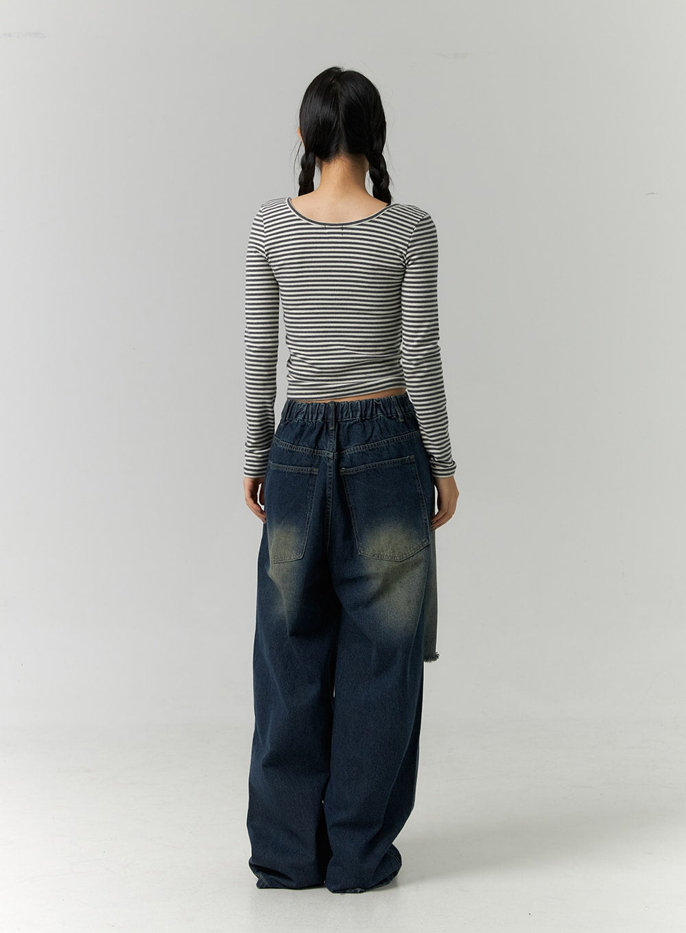 Destroyed Washed Wide Leg Jeans CN324 in dark blue, full-length back view on model, showing elasticated waistband, large patch back pockets, washed fade across seat, and pooling wide-leg hem.