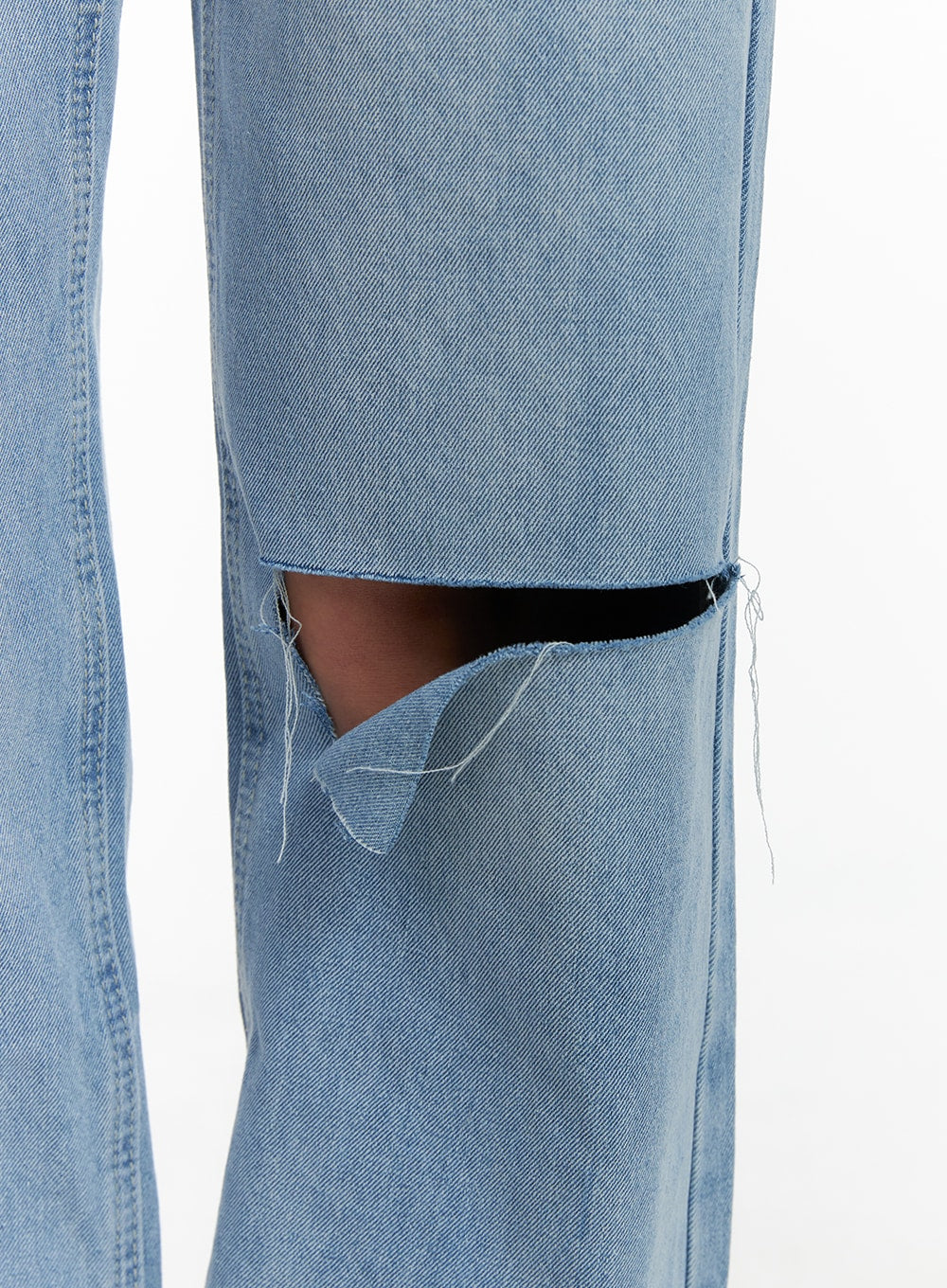 Cut Out Washed Straight Jeans OM421 in blue, macro close-up of thigh cut-out detail, raw frayed edges and destroyed distressed finish visible on washed light blue cotton denim.