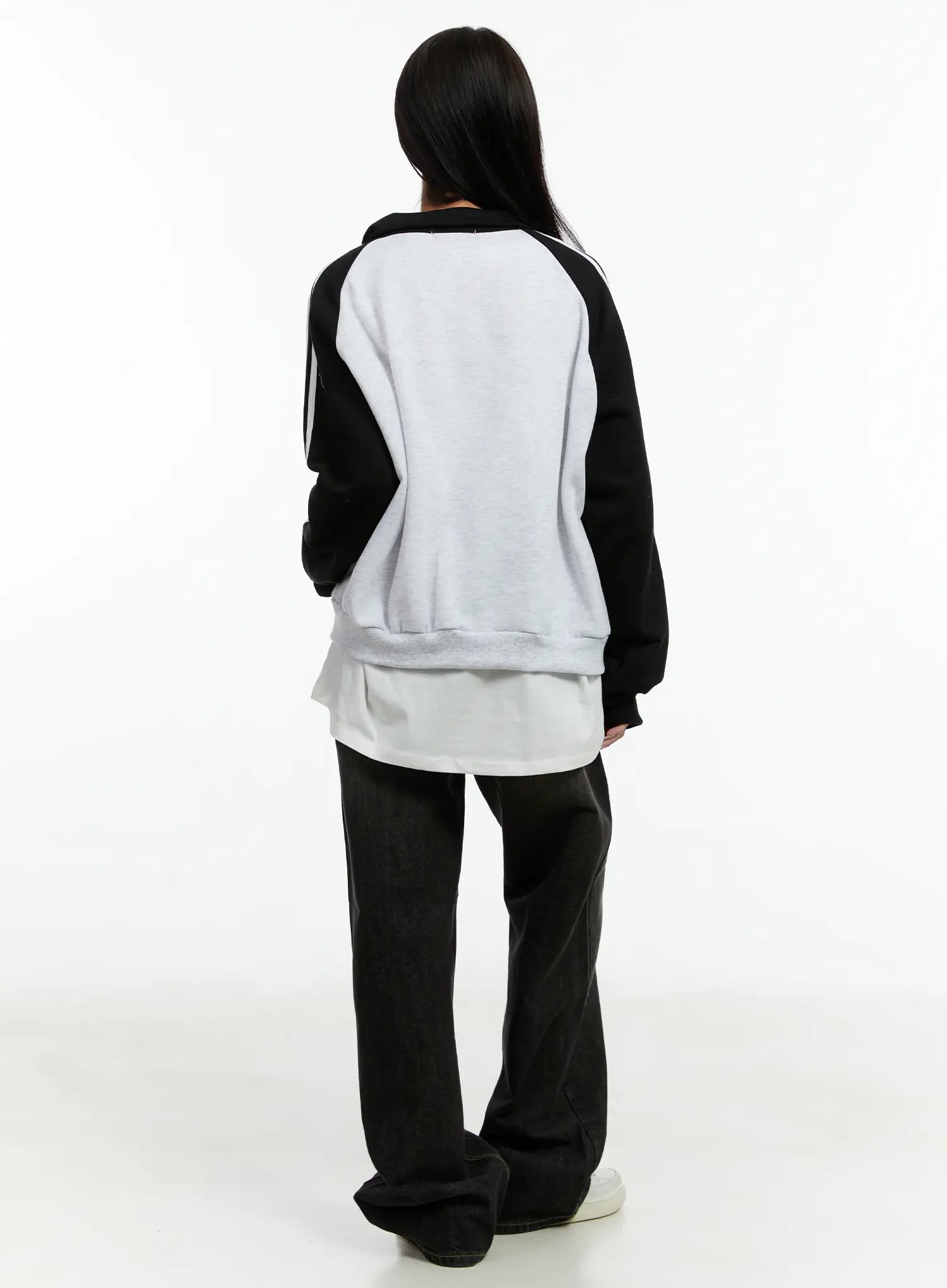 Haze Washed Wide-Leg Jeans CD523 in black, back full-body outfit shot on model, wide-leg hem pooling at sneakers, styled with two-tone zip-up hoodie and layered tee.
