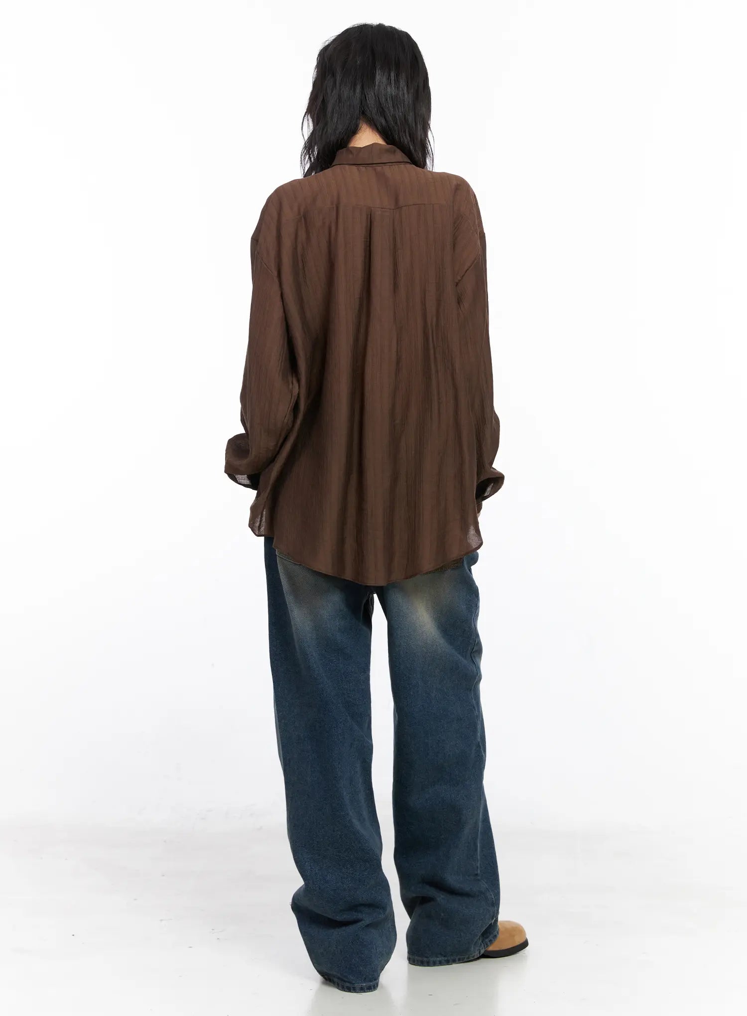 Xyla Vintage Pocket Baggy Jeans CO507 in blue, full back styling shot on model, baggy washed denim paired with brown striped long-sleeve shirt, tan boots.