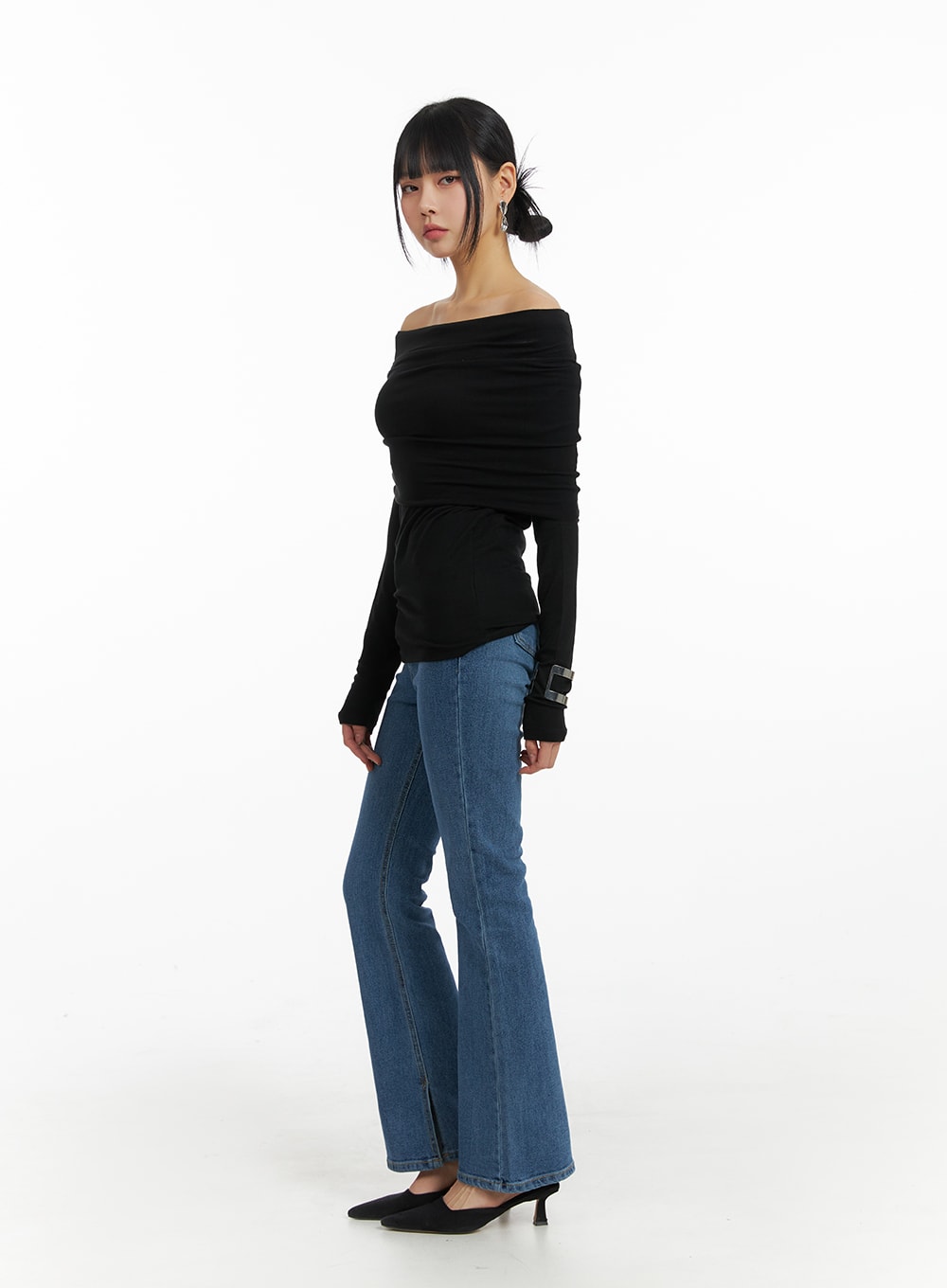 Vintage Flared Jeans IM414 in blue, side full-length on model, slim bootcut silhouette with washed finish, styled with black off-shoulder ruched top and black heels.