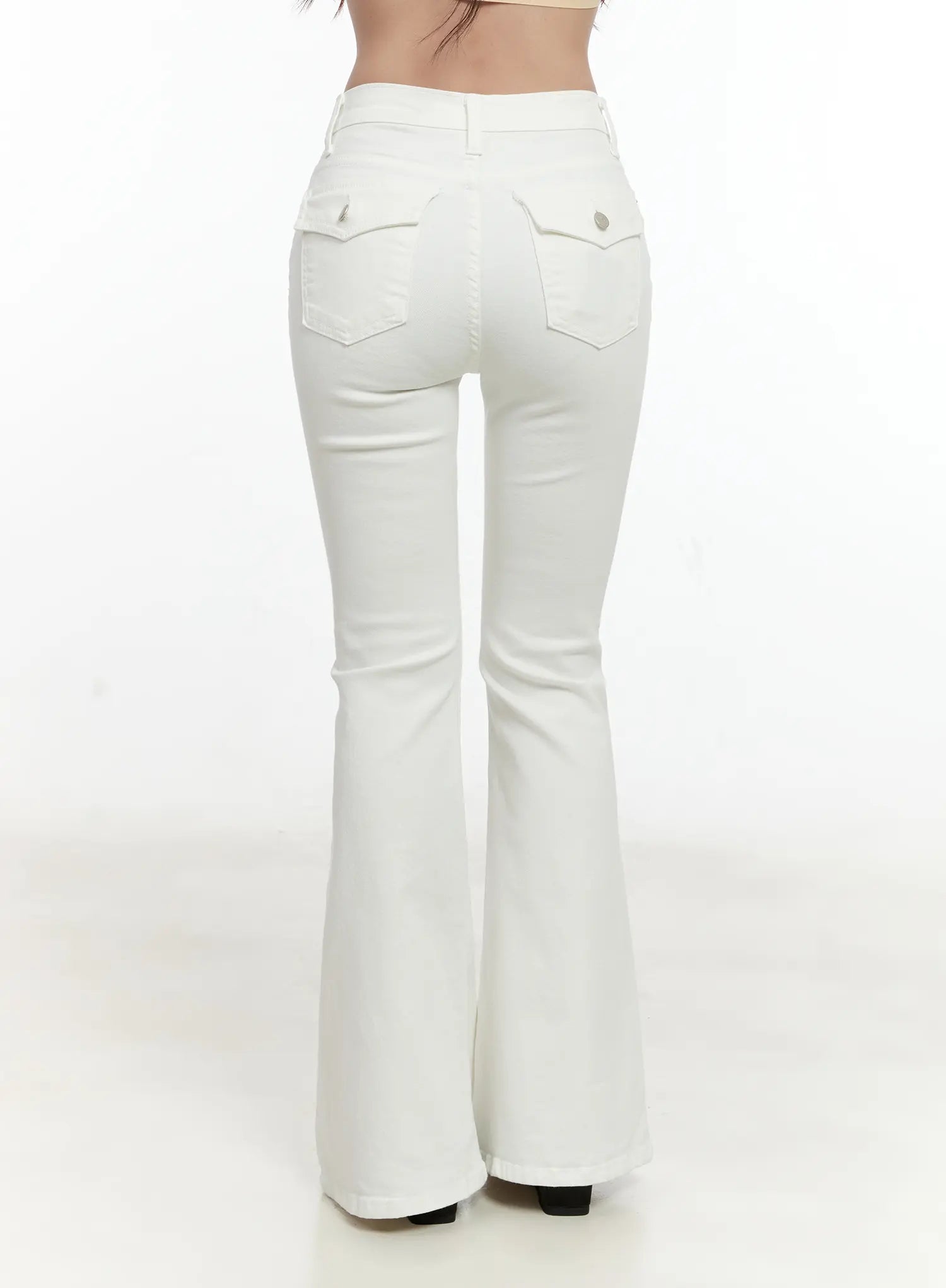 High-Waist Flare Pants CG501 in white, back view on model, full-length shot showing dual flap back pockets, center seam, and wide bootcut flare hem.