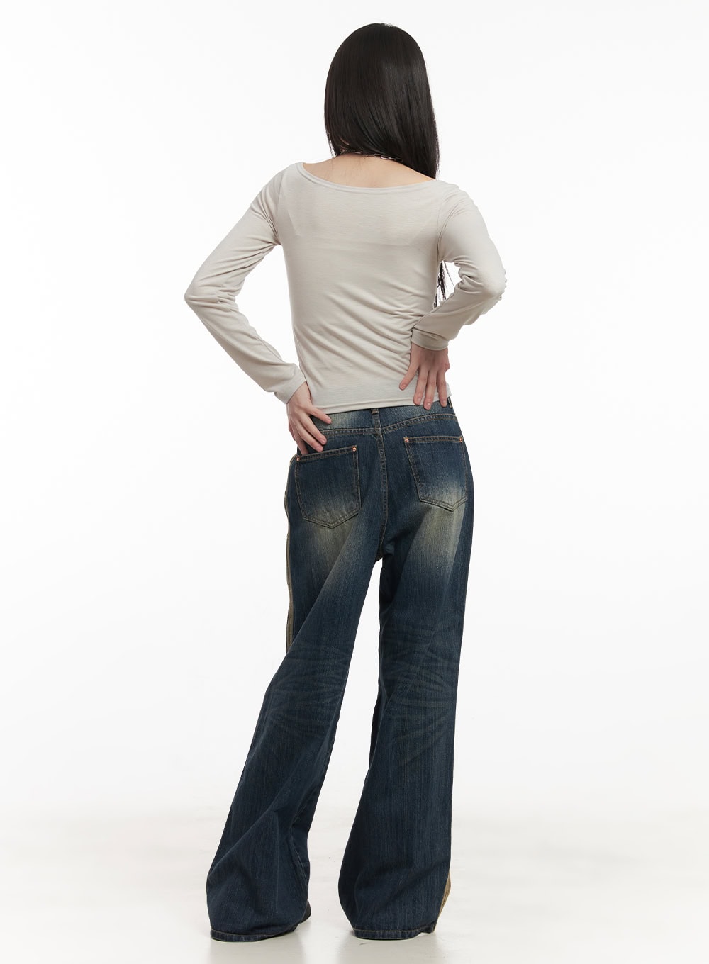 Daisee Striped Wide-Leg Jeans CF518 in dark blue, full back view on model, wide-leg washed denim with gold side stripe visible at edges, paired with beige long-sleeve top.