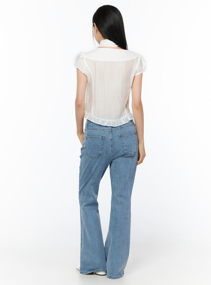 Puff Sleeve Shirred Blouse with Scarf IU519 in white, back view on model, showing sheer fabric, subtle shirring texture, ruffled hem and scarf at neckline, with blue flare jeans.