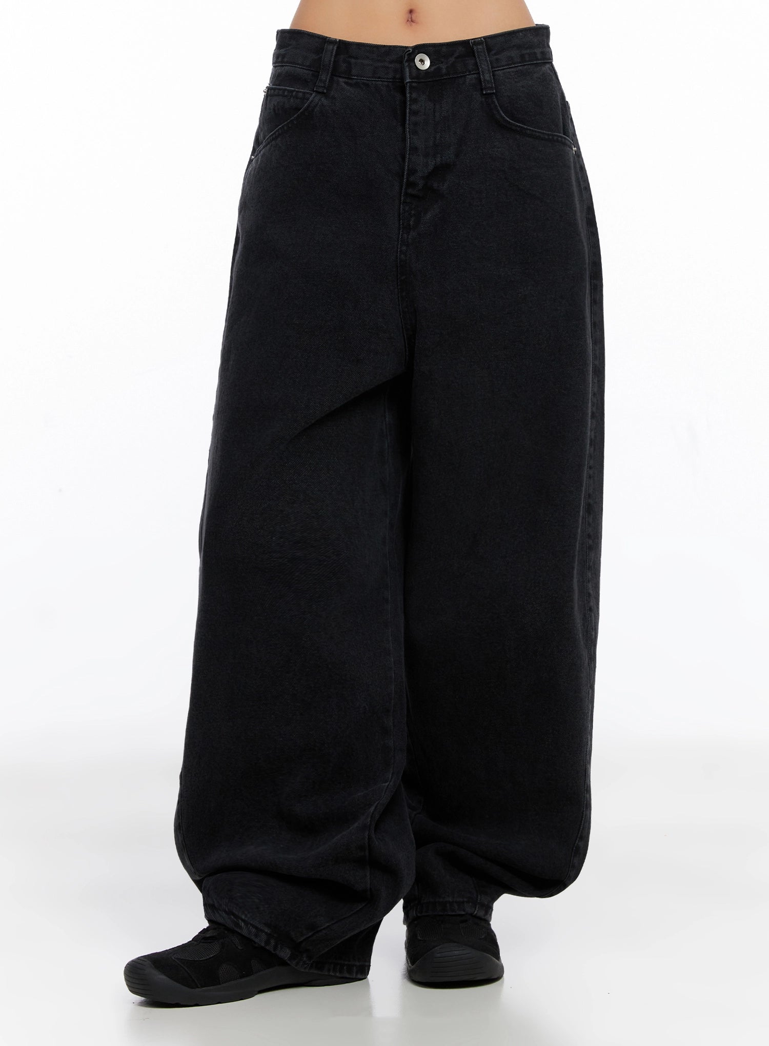 Sunwoo Embroidered Wide Leg Jeans IG528 in black, front waist-to-hem product shot on model, balloon-silhouette cotton denim with front pockets, extreme wide leg bunching at hem over sneakers.