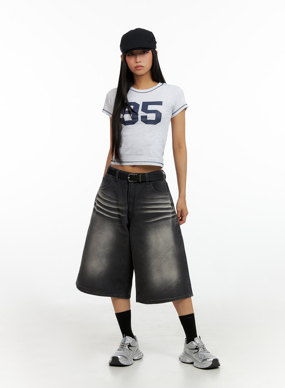 Washed Baggy Jorts IL419 in black, front full-body standing on model, wide-fit midi denim with heavy fade wash and crinkle detailing, black belt, styled with cropped graphic tee.