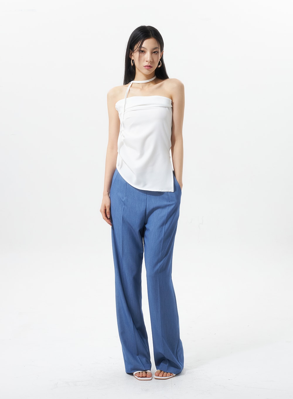 Low Rise Tailored Pants IU326 in blue, full-body front view on model facing camera, wide-leg trouser cut with low waist, solid minimal style, paired with white halter top.