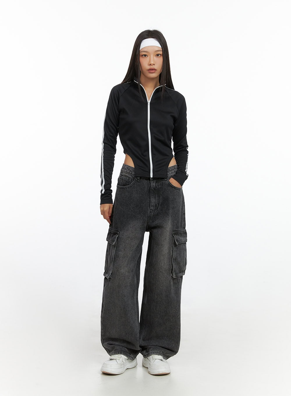 Neve Washed Cargo Denim Jeans IS427 in washed black, front full-length shot on model standing straight, baggy wide-leg fit with large cargo pockets, paired with black stripe zip-up crop top.