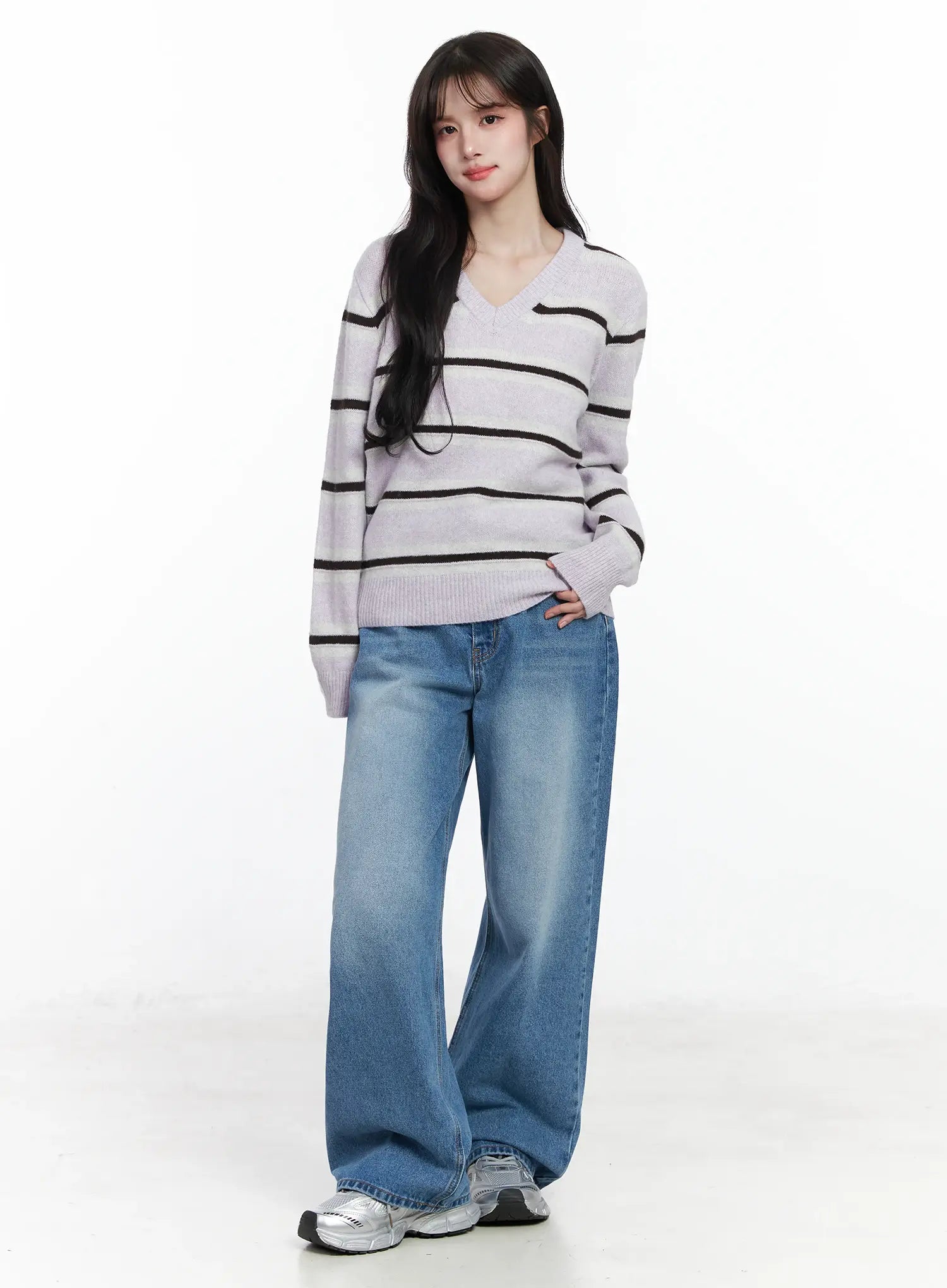 Iliana Wide Leg Jeans IJ529 in blue, full-body front shot on model, wide-leg washed denim styled with lavender striped V-neck knit sweater and silver sneakers.