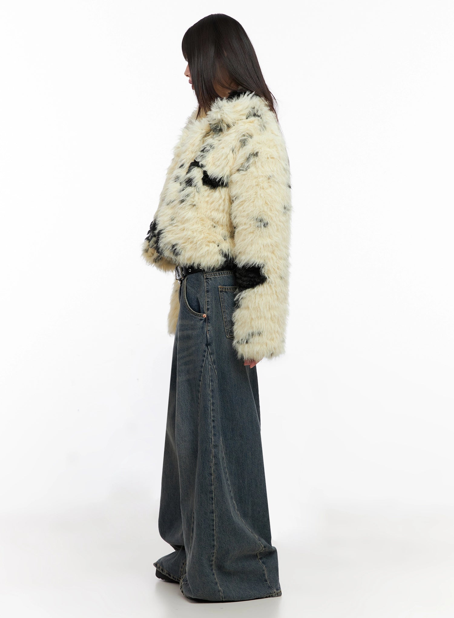 Skyler Washed Balloon Fit Jeans IN503 in blue, pure side view on model, balloon-fit wide leg silhouette visible against faux-fur outer, washed indigo cotton, full floor length.