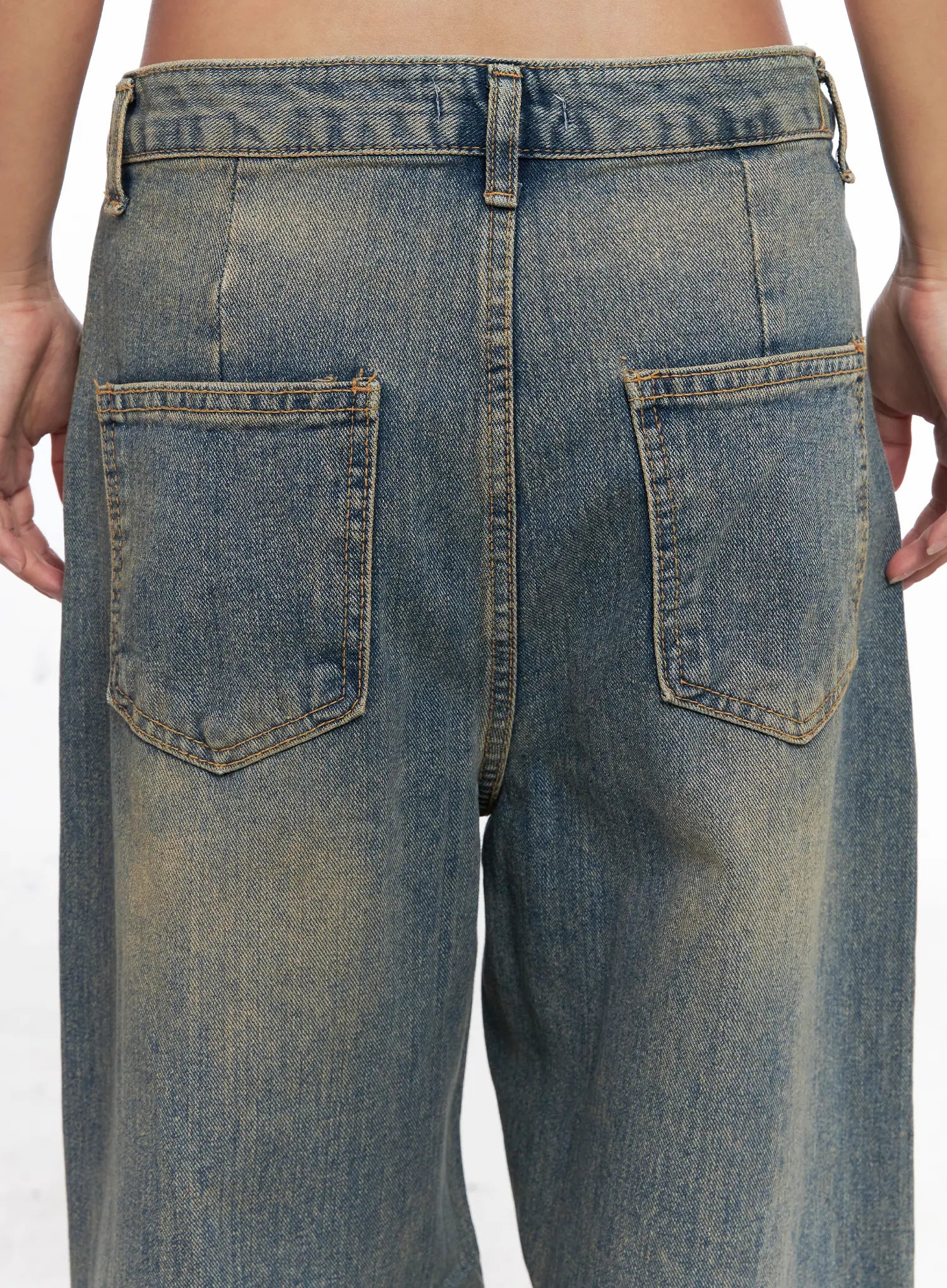 Denver Vintage Washed Semi-Wide Jeans CO513 in blue, close-up back detail shot showing dual patch pockets, contrast topstitching, and vintage amber wash fading on cotton denim waistband area.