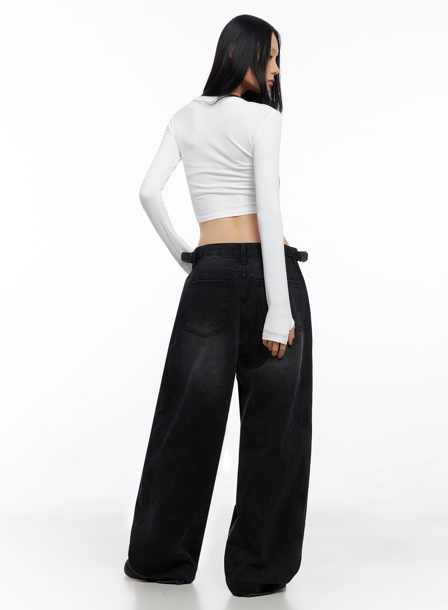 Goffel Side Belt Washed Wide Denim Pants IO517 in black, back view on model, showing single back pocket, side belt hardware, wide leg silhouette, paired with white crop top.