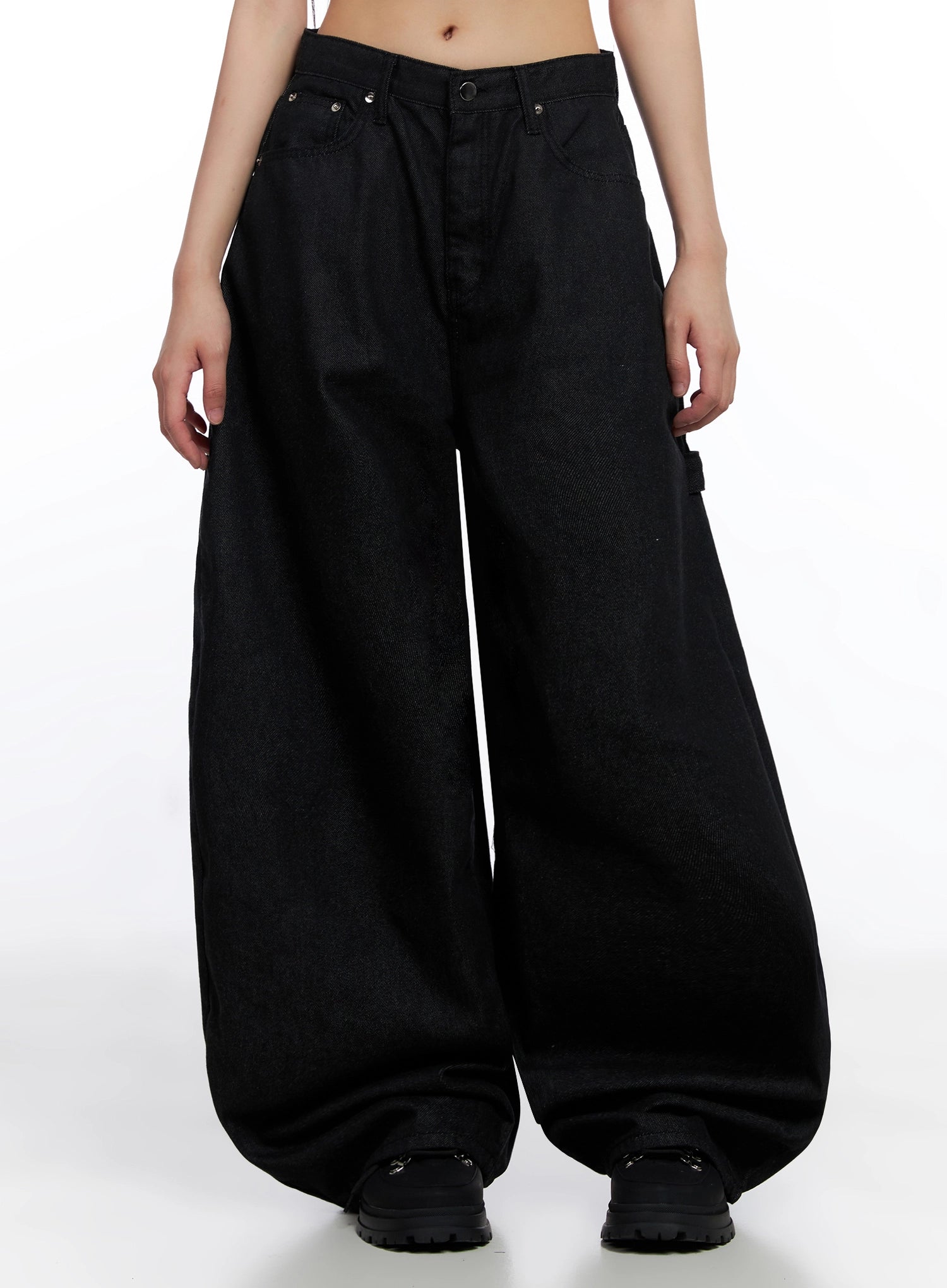 Lea Cross-Patch Baggy Jeans IS525 in black, front mid-length clean product shot on model, ultra-wide balloon leg silhouette in cotton denim, silver rivet details at pockets, hem pooling over black boots.