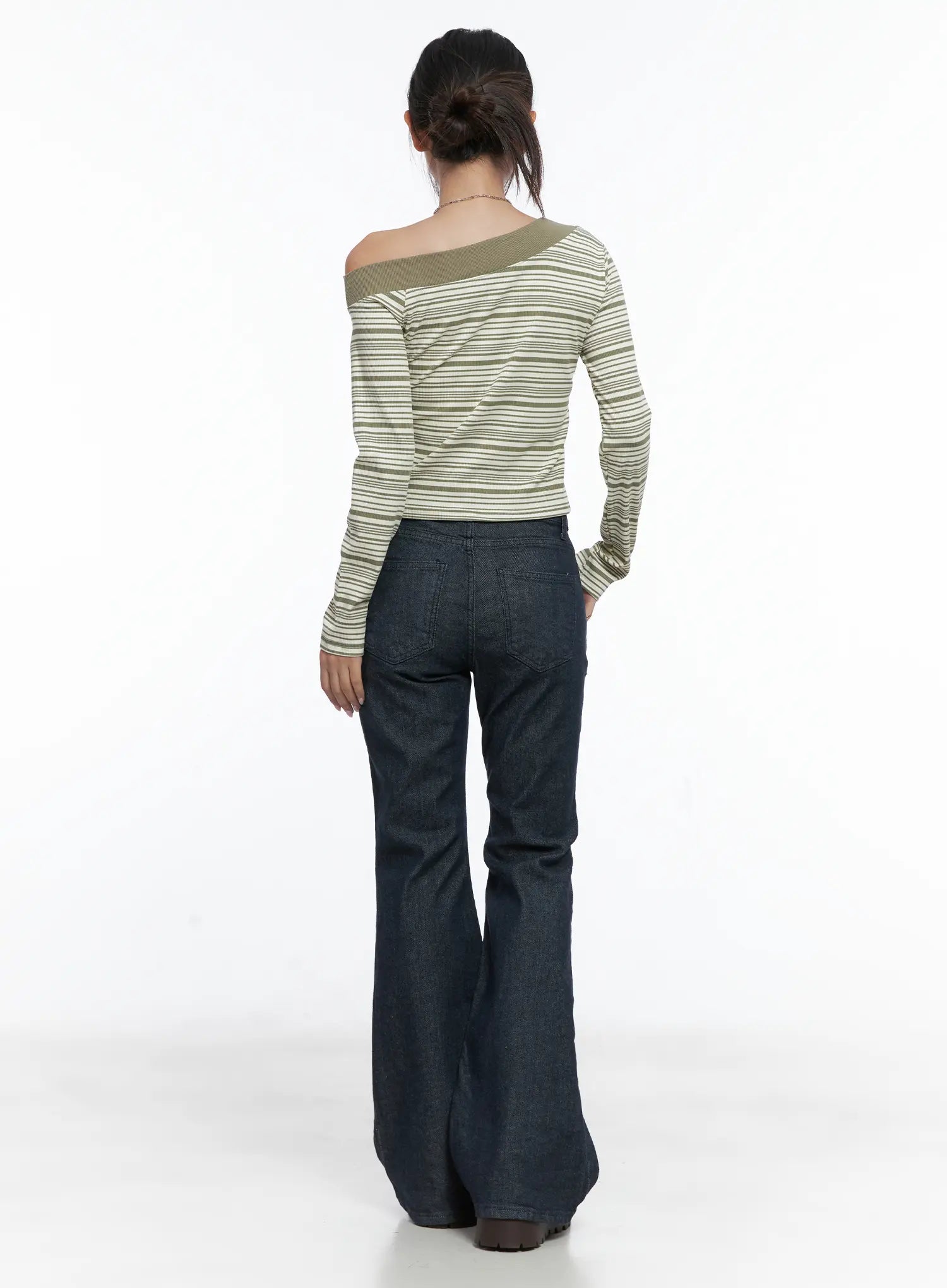 Kinley Flare Jeans CS502 in dark indigo, back full-length view on model styled with striped off-shoulder top, flare silhouette and waistband seam detail visible.